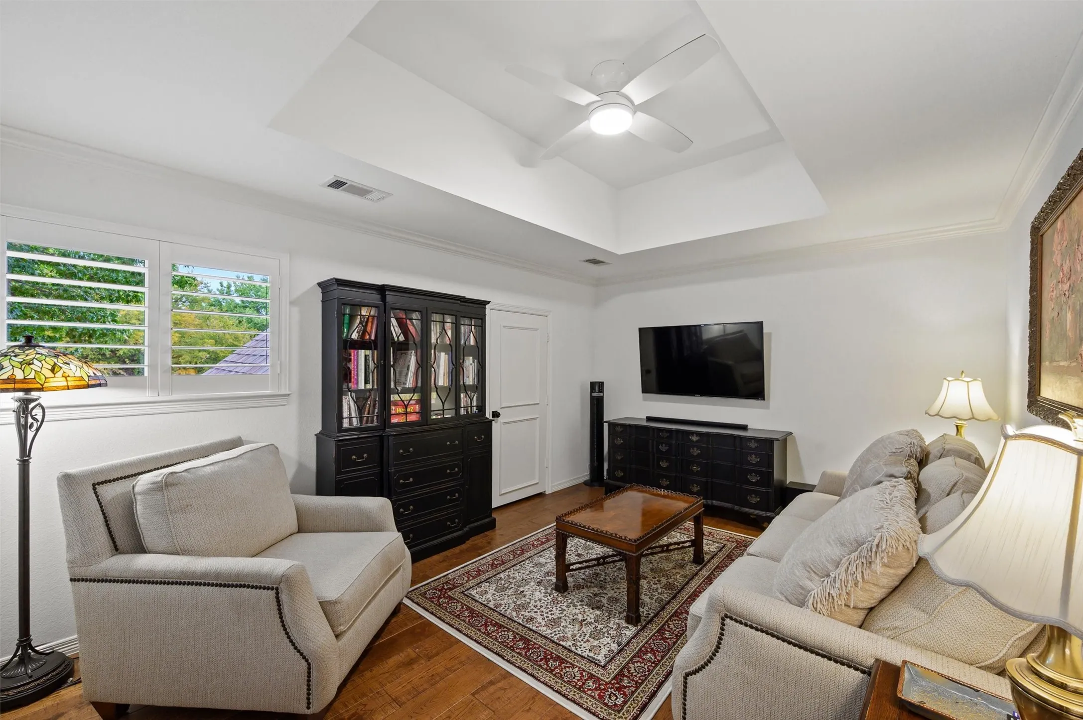 Wood-finish flooring with white walls and crown molding