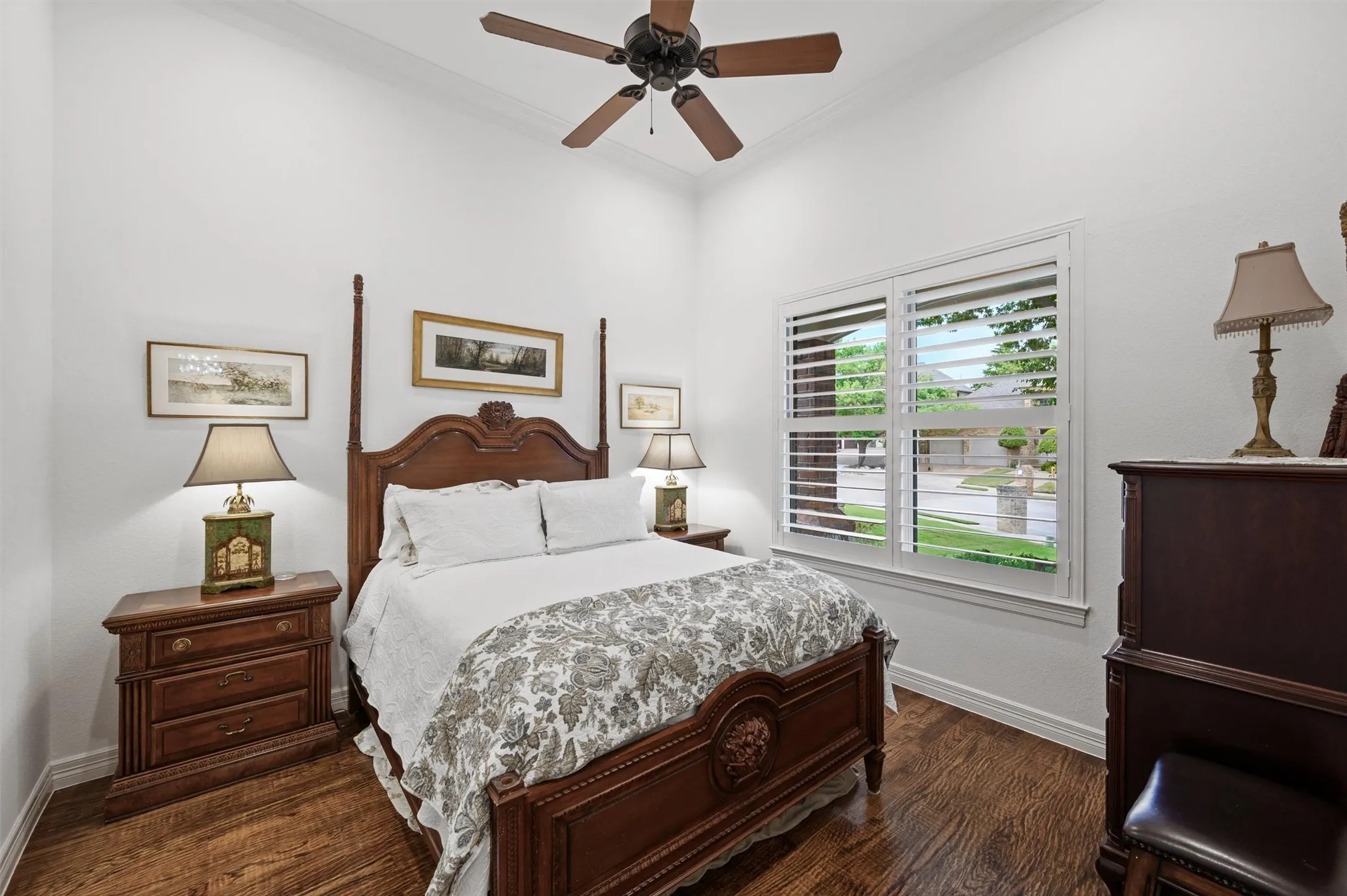 Wood-finish flooring, high ceilings, and a ceiling fan with light fixture