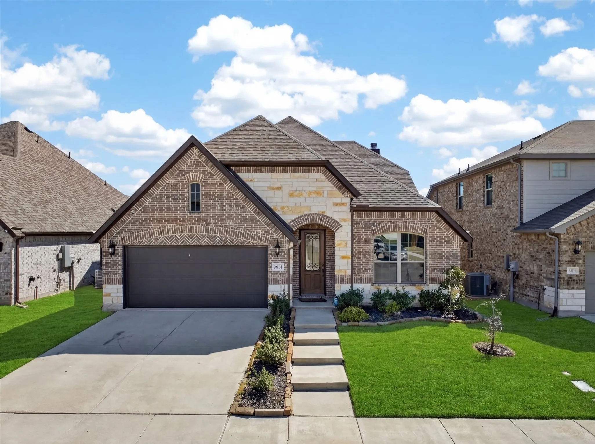 Brick and stone exterior with an arched entry