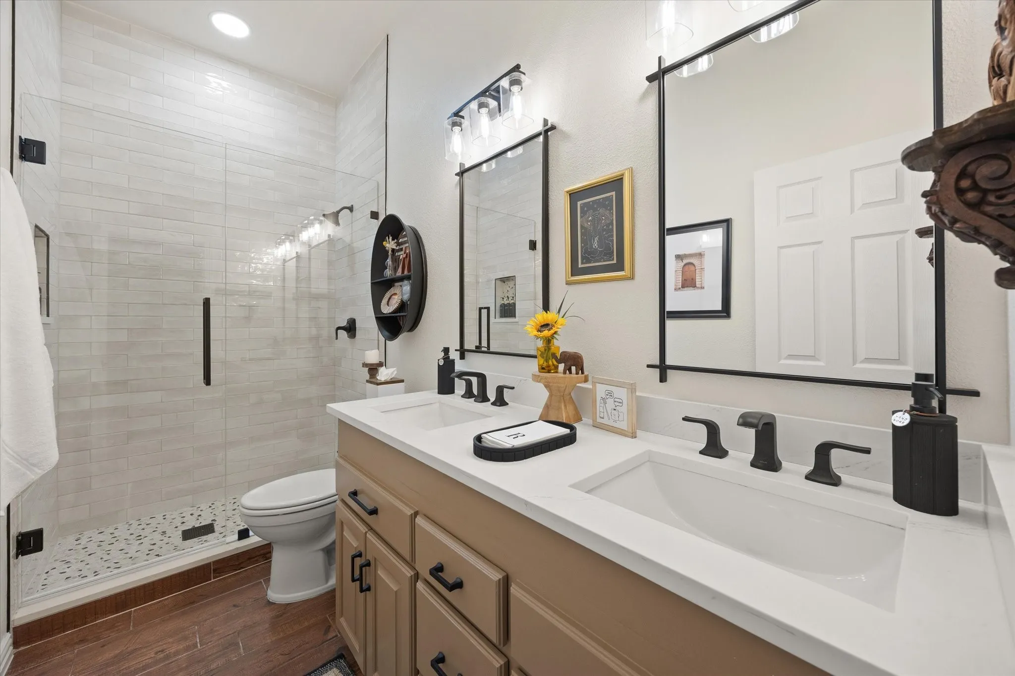 Updated Secondary Bathroom Featuring Oversized Shower with Frameless Glass Door, Quartz Countertop, Kohler Fixtures, Framed Mirrors and Designer Light Fixtures
