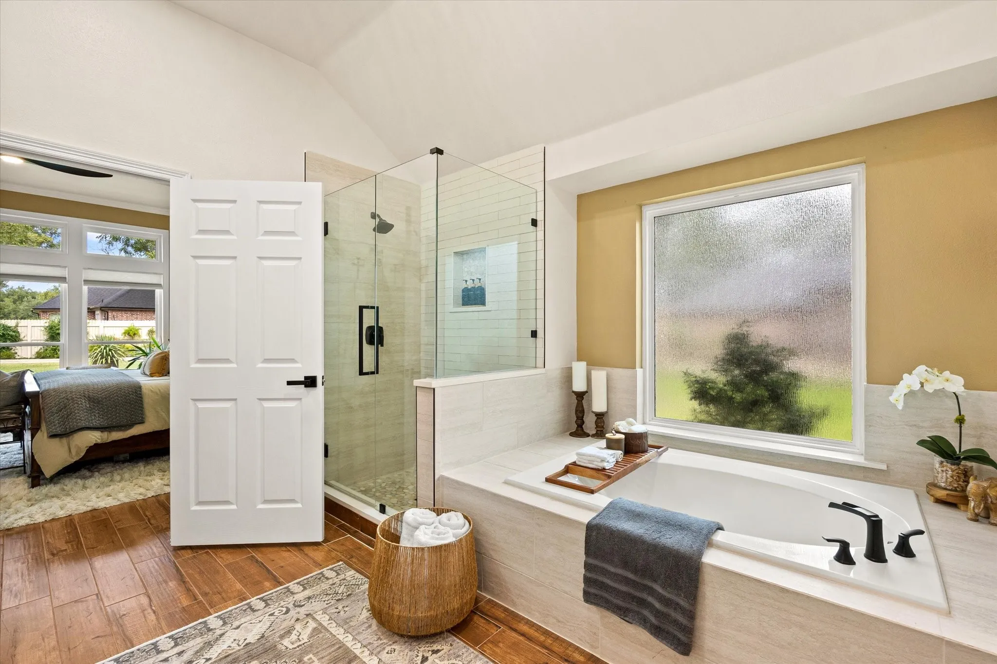 Large En Suite Primary Bathroom Featuring Large Garden Tub with New Tile Surround, Updated Shower with Frameless Glass Door, Kohler Fixtures and Designer Paint
