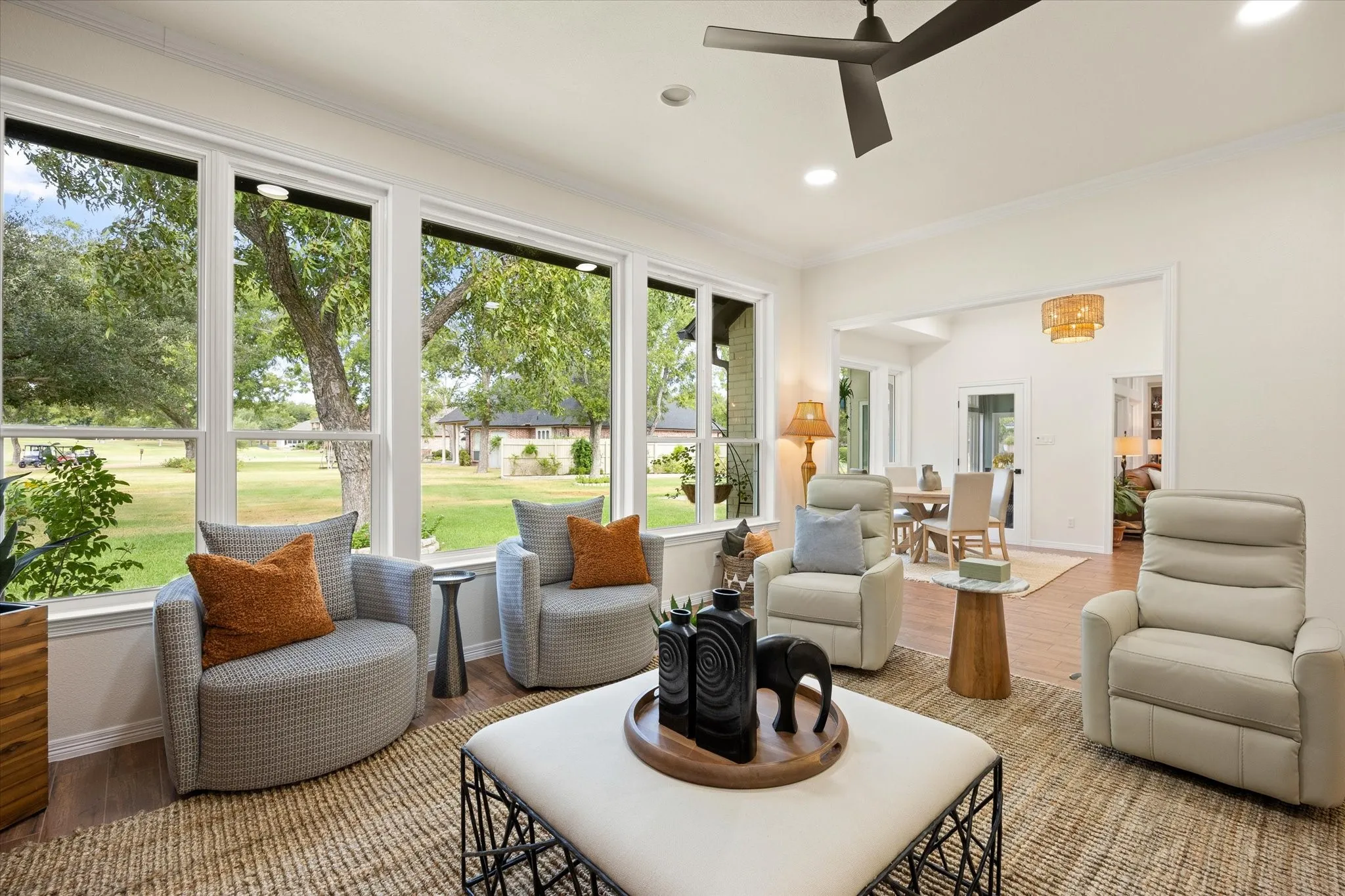 Oversized Den with Wall of Windows Overlooking Golf Course Green and Fountain
