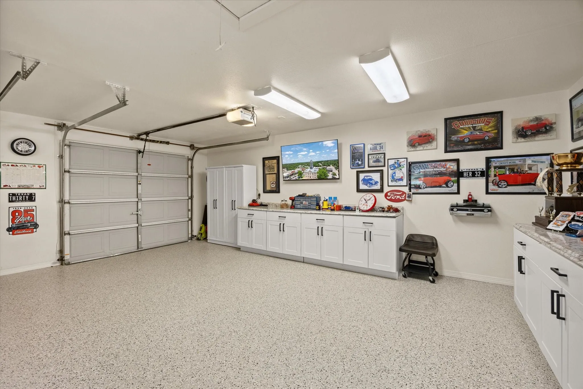 Oversized 3 Car Garage with Epoxy Flooring, New Overhead LED Light Fixtures, New Ceiling Fan and New Metal Pull Down Attic Stairs.  All Cabinets will Remain with the Home