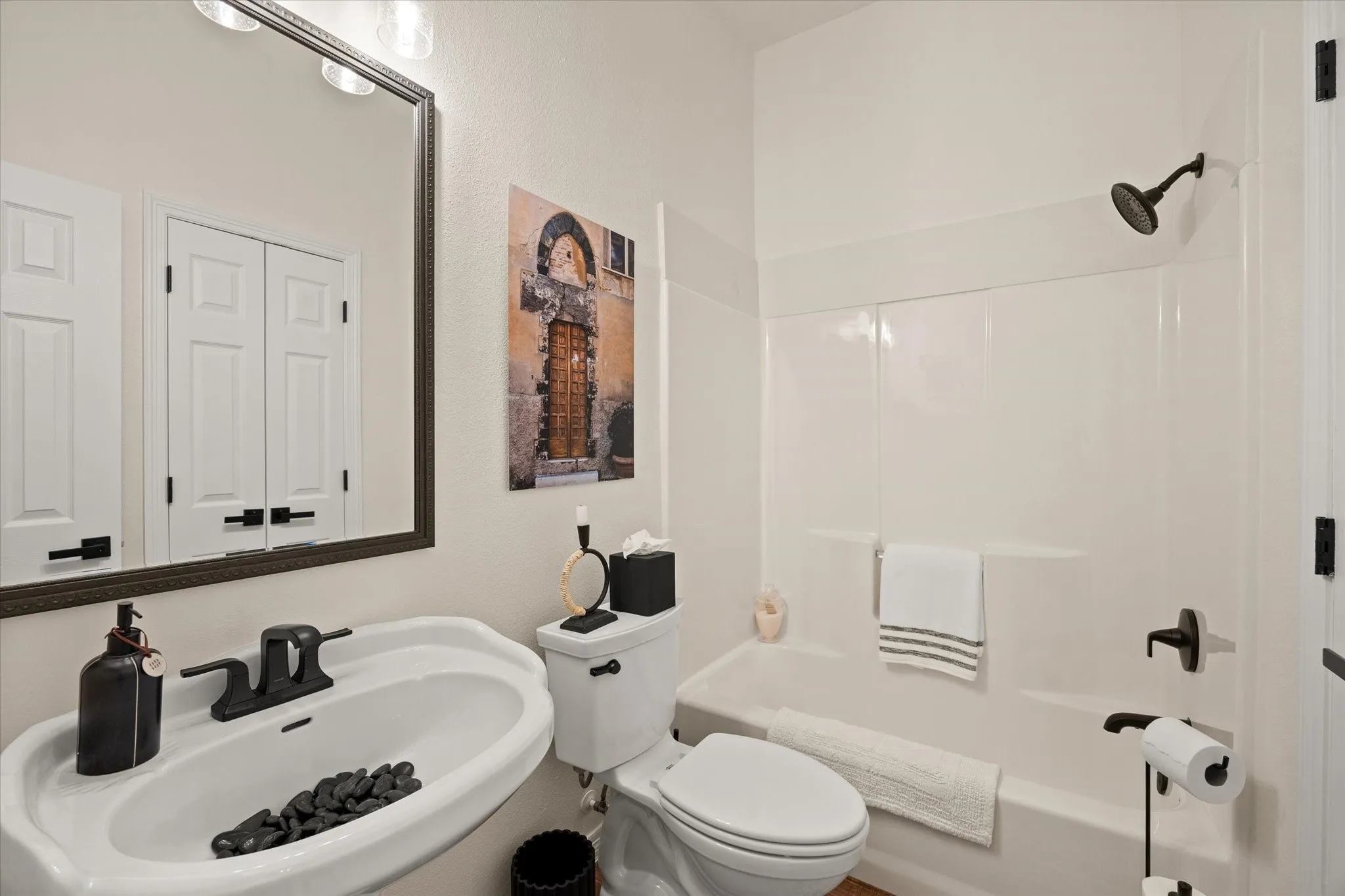 Secondary Full Bathroom with Oversized Linen Closet, Kohler Fixtures, Framed Mirror and Updated Light Fixtures