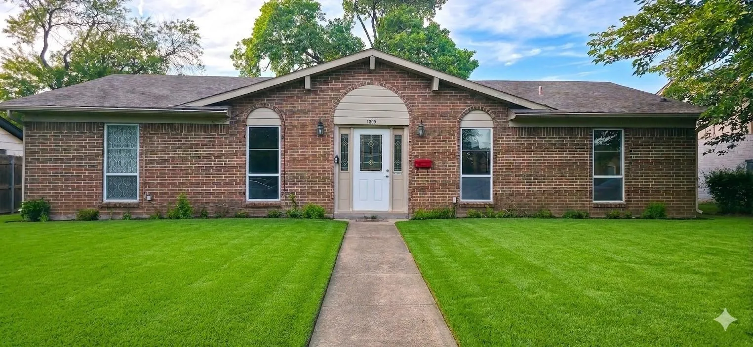 Brick exterior with arched window details, a prominent central entryway, a gabled roofline, a concrete pathway, and a lush green lawn