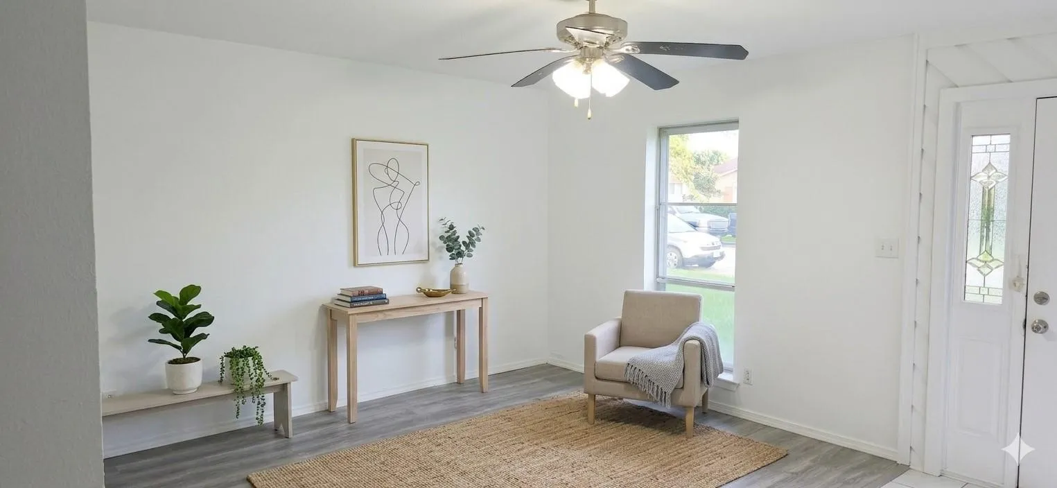 Wood-finish flooring, a ceiling fan with integrated lighting, a large window, and a white entry door with decorative glass paneling
