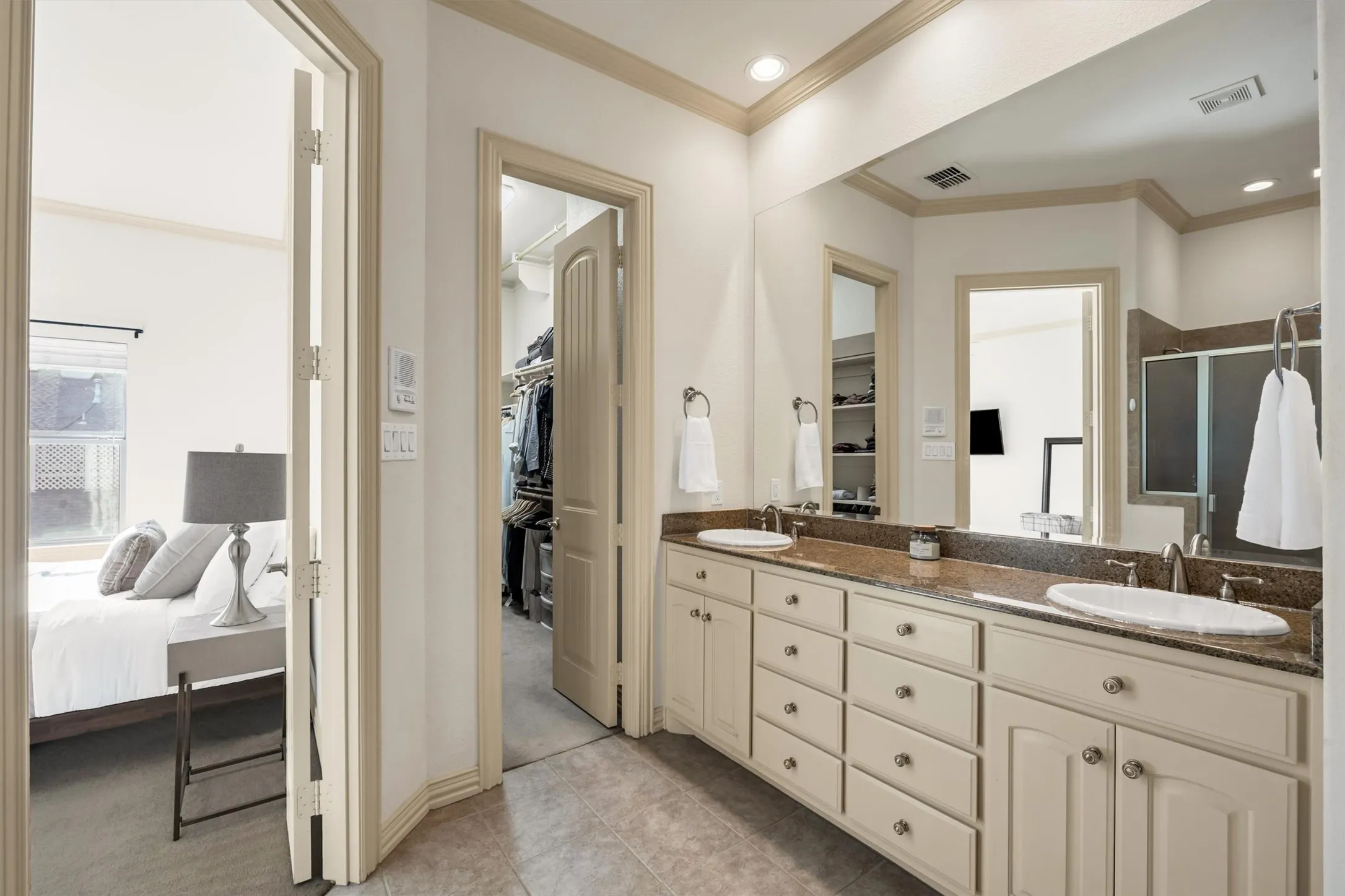 Dual vanity with undermount sinks, substantial countertop, and extensive storage cabinetry