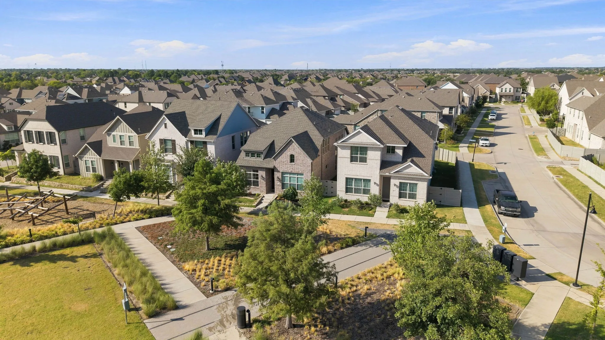 Paved sidewalks and streets, mature trees, and landscaping throughout the neighborhood