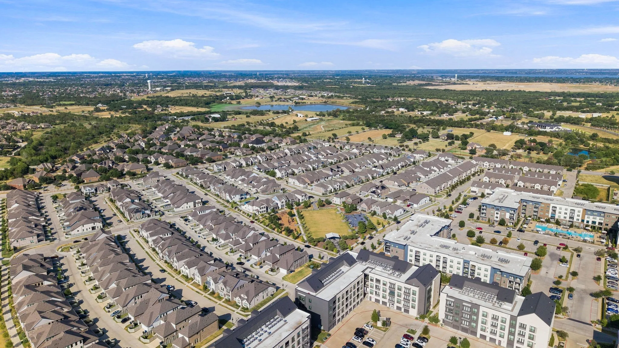 Expansive residential development featuring numerous single-family homes and multi-story apartment buildings