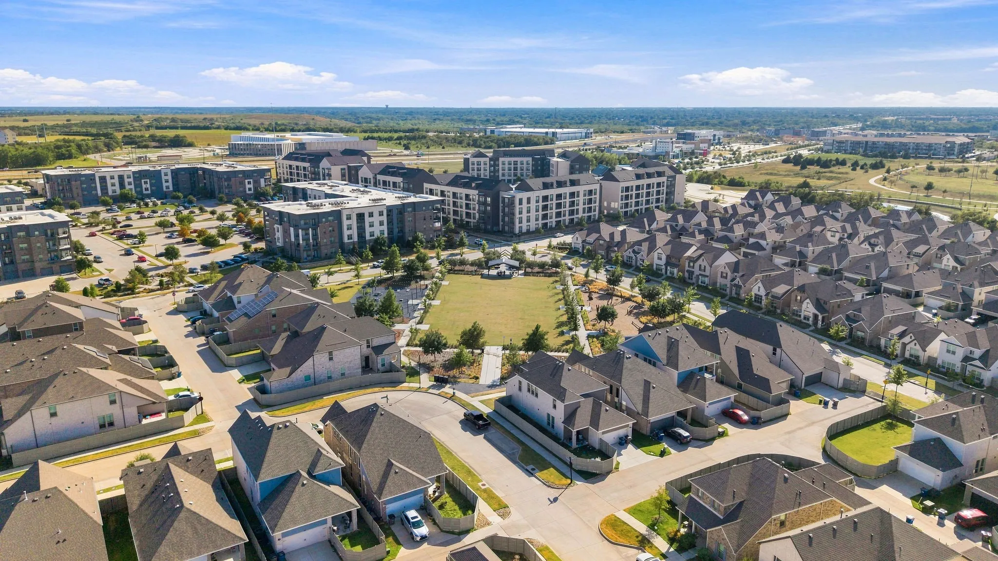 Residential development featuring single-family homes and multi-story apartment buildings