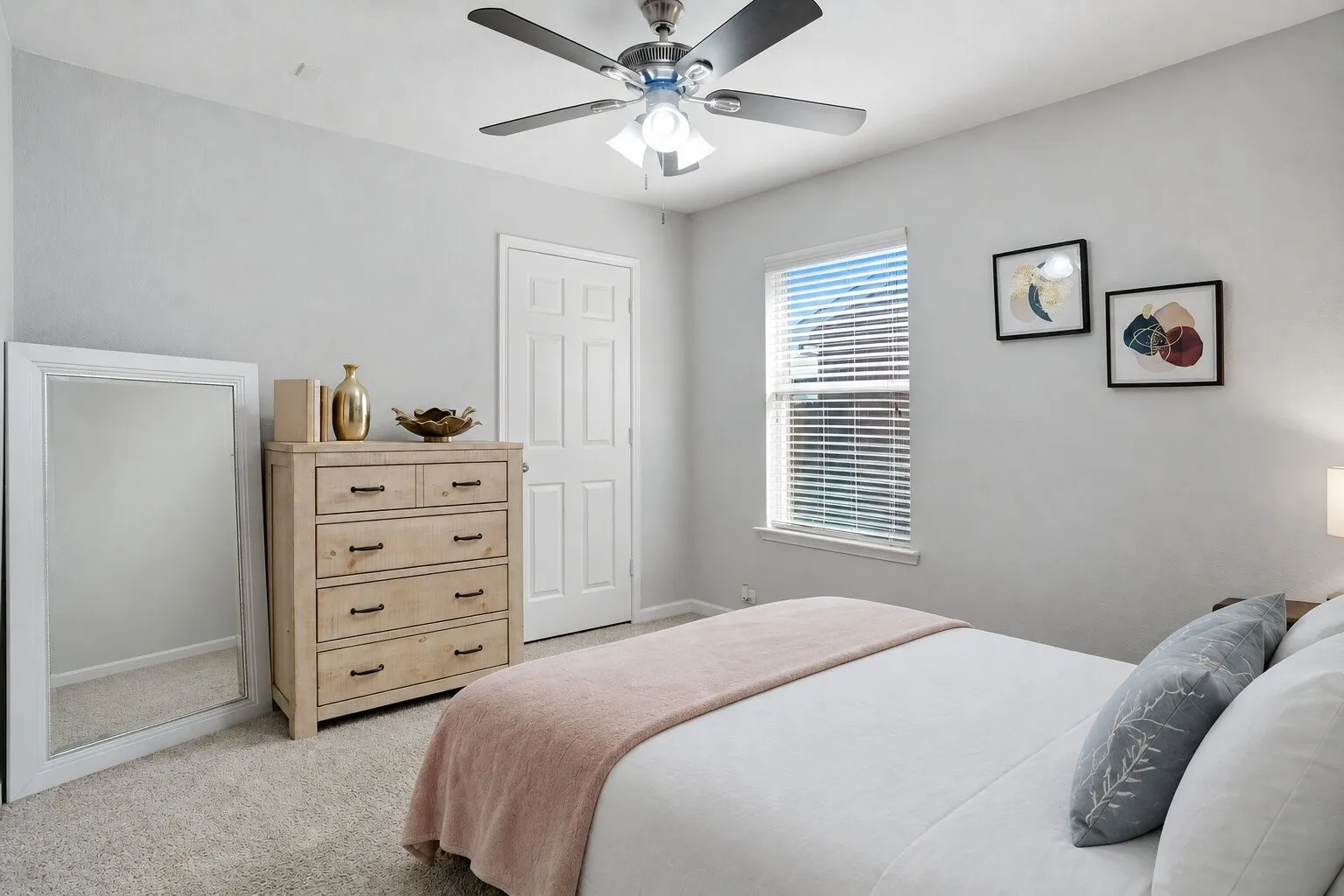 Comfortable secondary bedroom featuring natural light, a ceiling fan, ample closet space, and room for additional furniture. Photos have been AI enhanced for presentation; no material property features were altered.