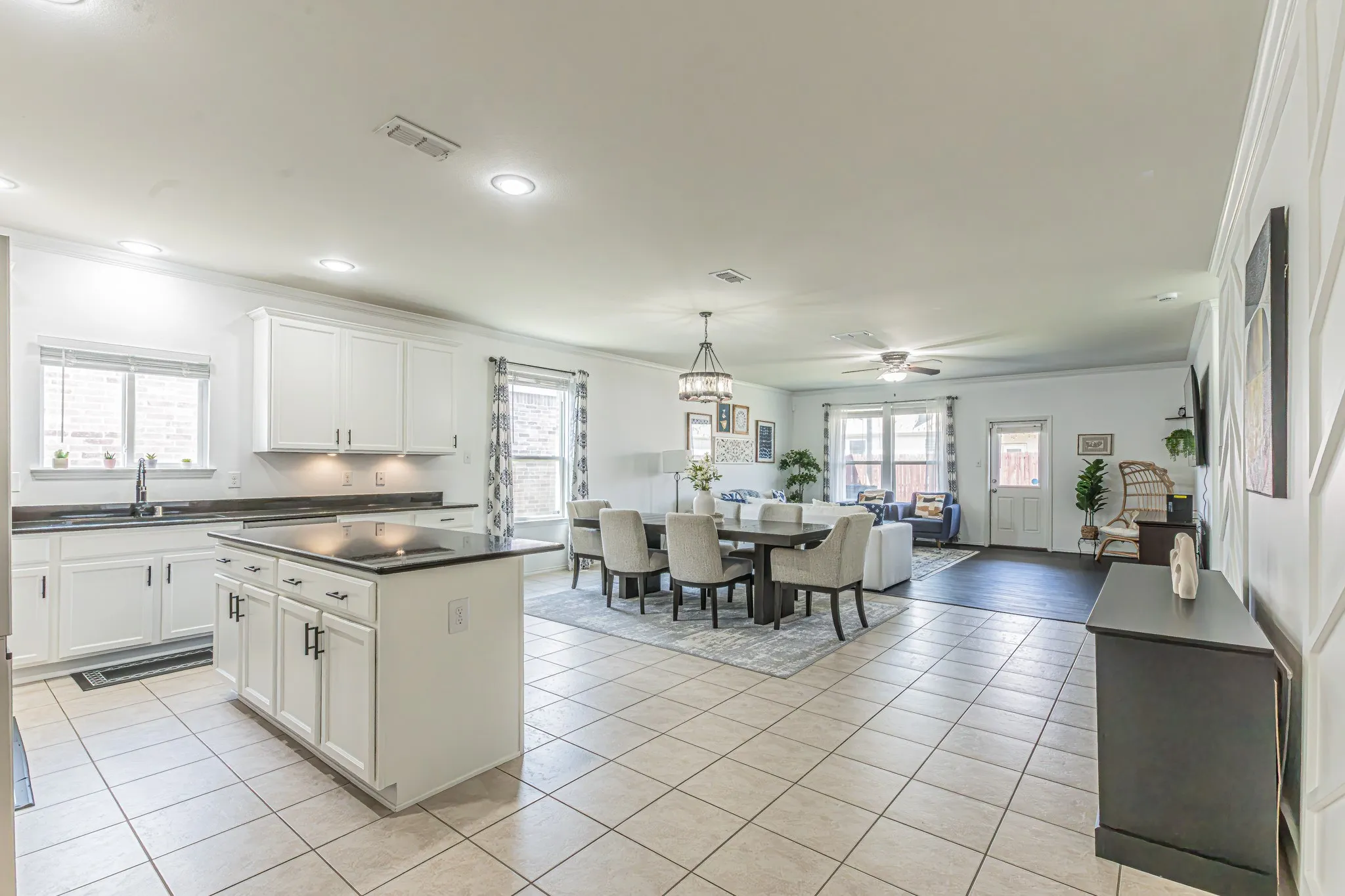 Follow the entry hall into this open concept kitchen, dining, and living space.