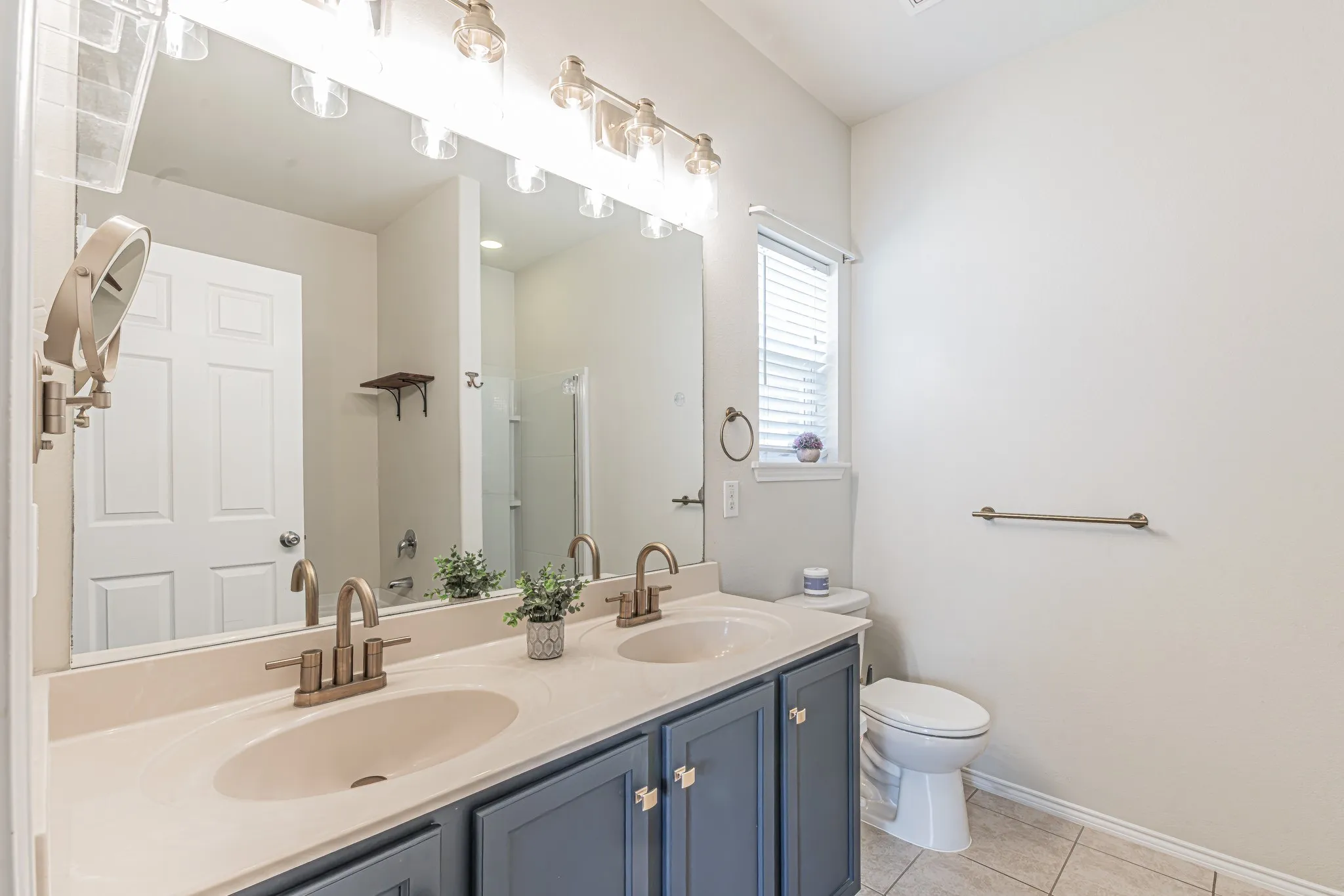 Primary bathroom with dual sinks, and a separate tub and shower.