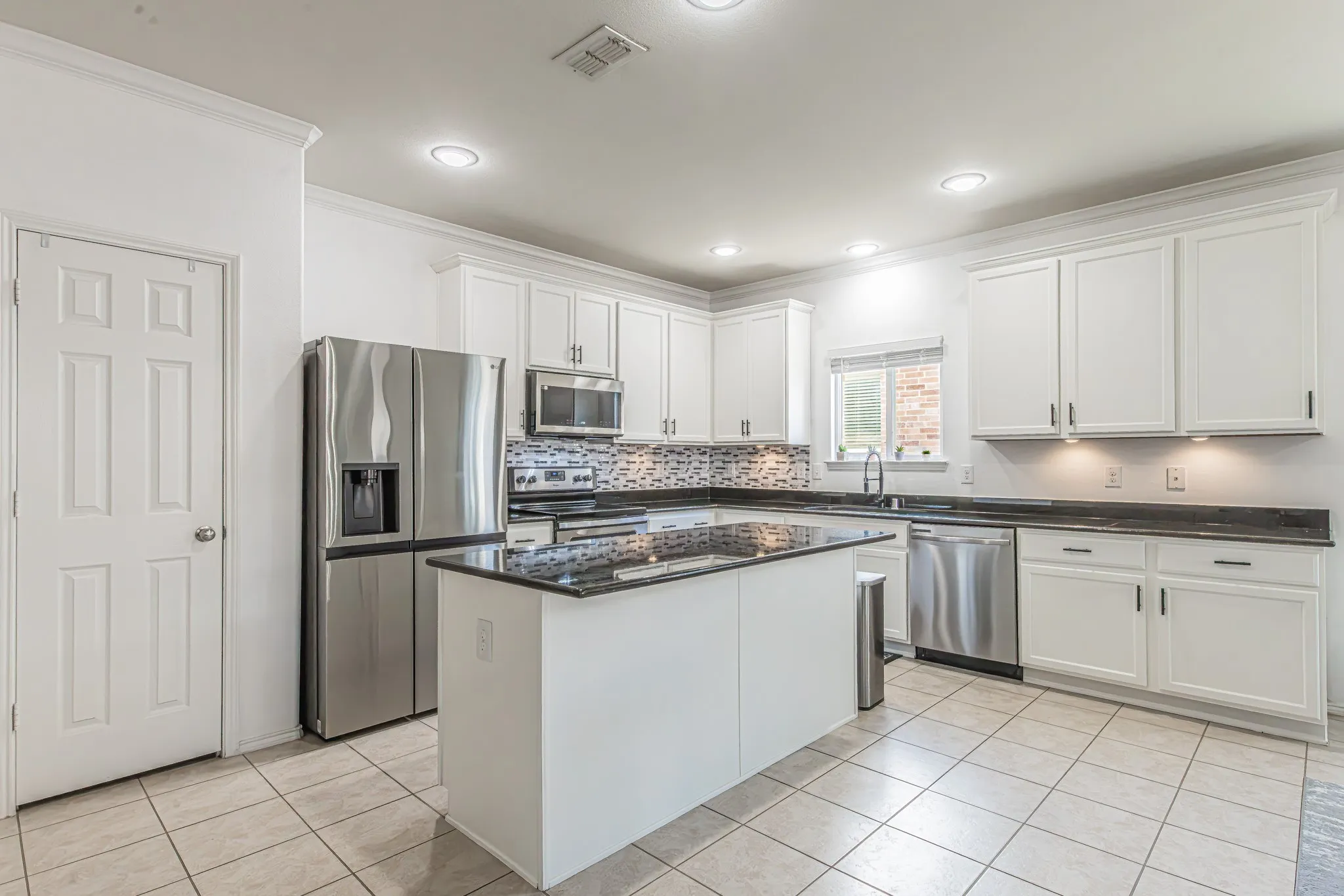 Beautiful kitchen with tons of cabinets and counterspace.