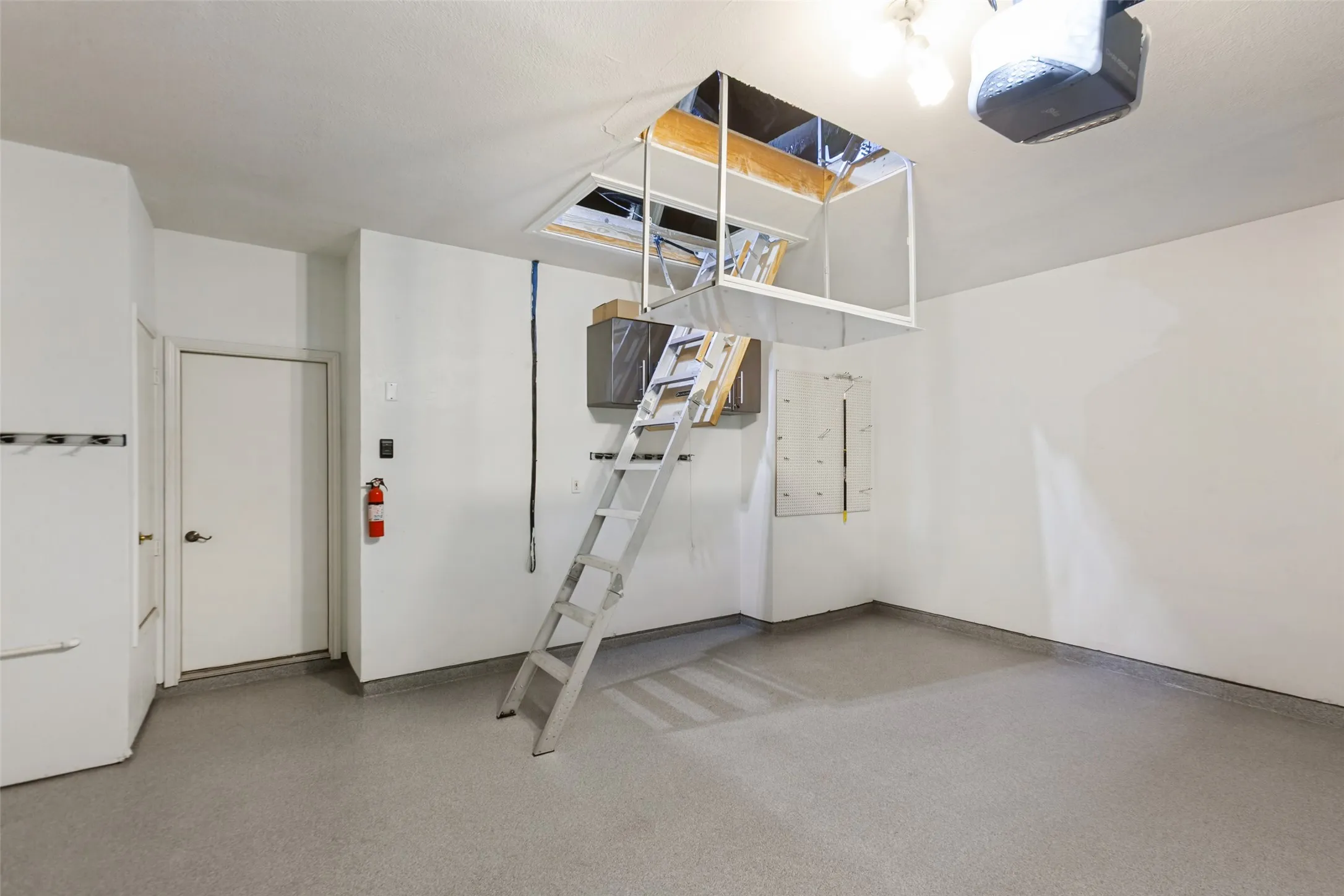 Floored Attic for Storage and Electronic Lift to move items to attic.