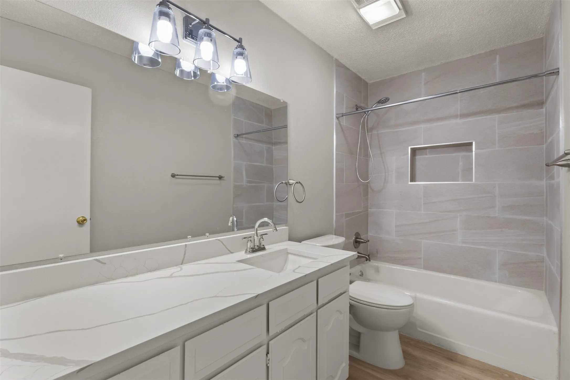 Vanity with a white countertop and integrated sink, chrome faucet, and white cabinetry
