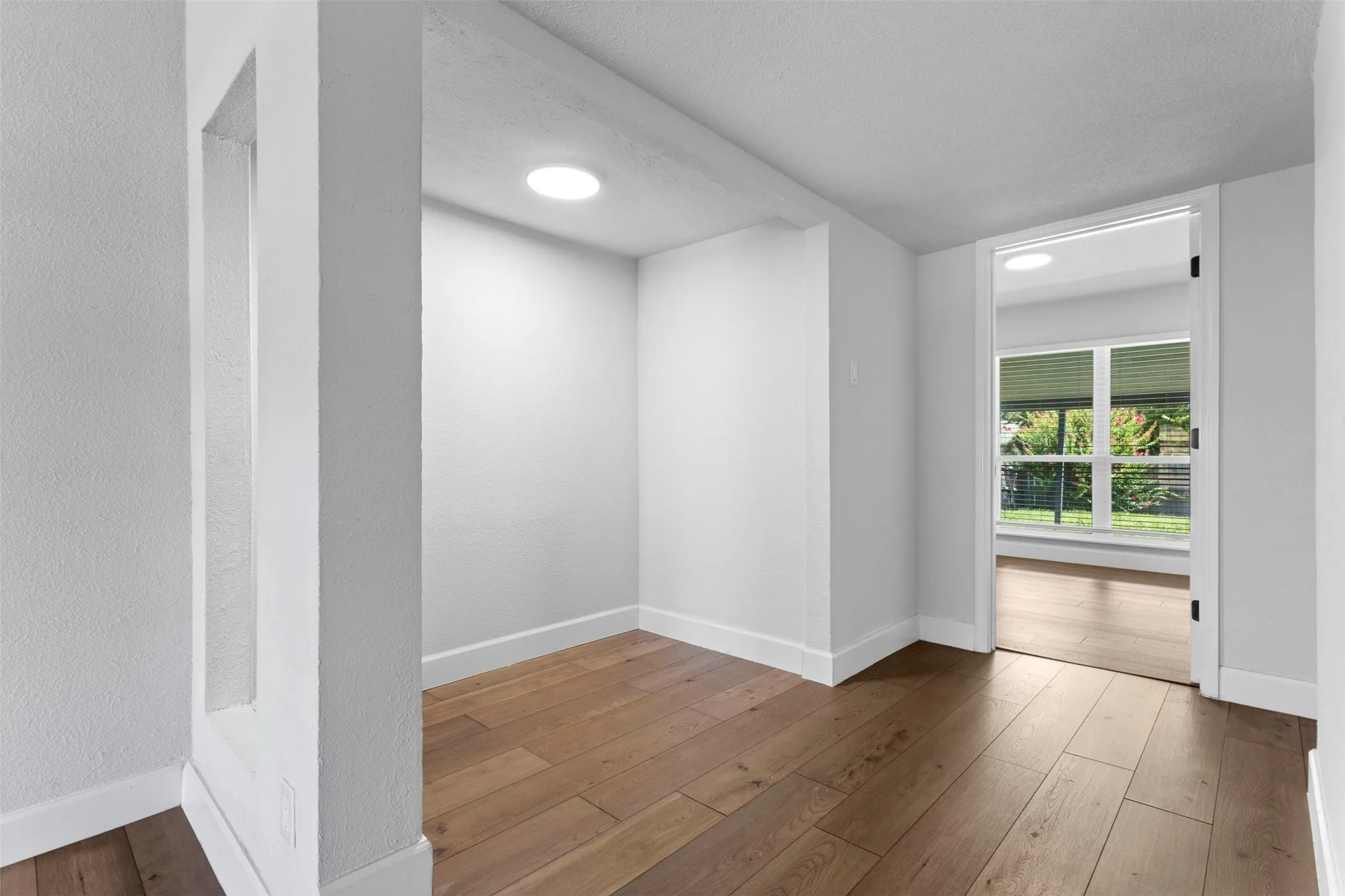 Wood-finish flooring throughout, recessed lighting, and a built-in wall​​‌​​​​‌​​‌‌​‌‌​​​‌‌​‌​‌​‌​​​‌​​ niche