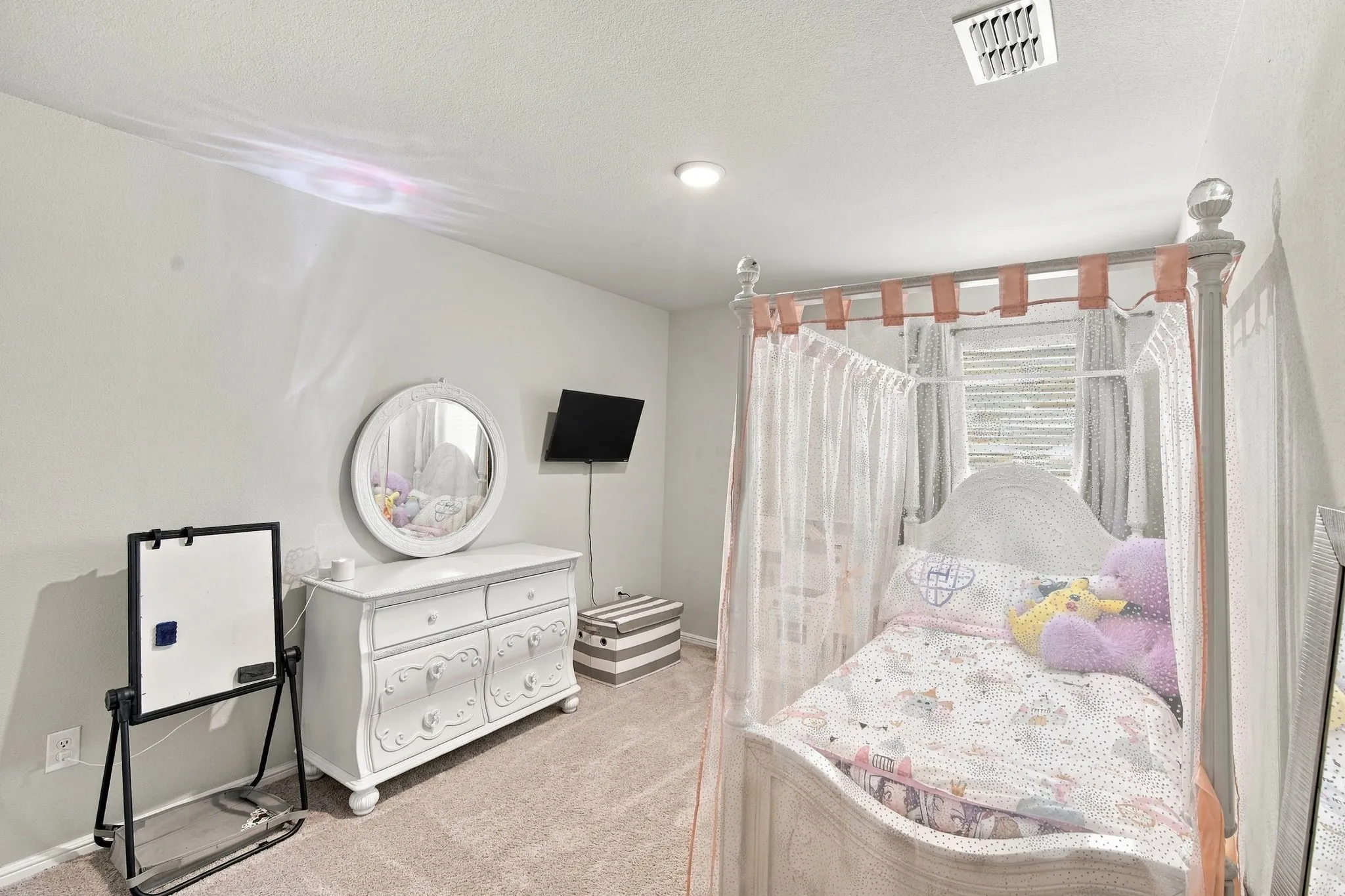 Recessed ceiling lighting, textured wall finish, and carpeted flooring
