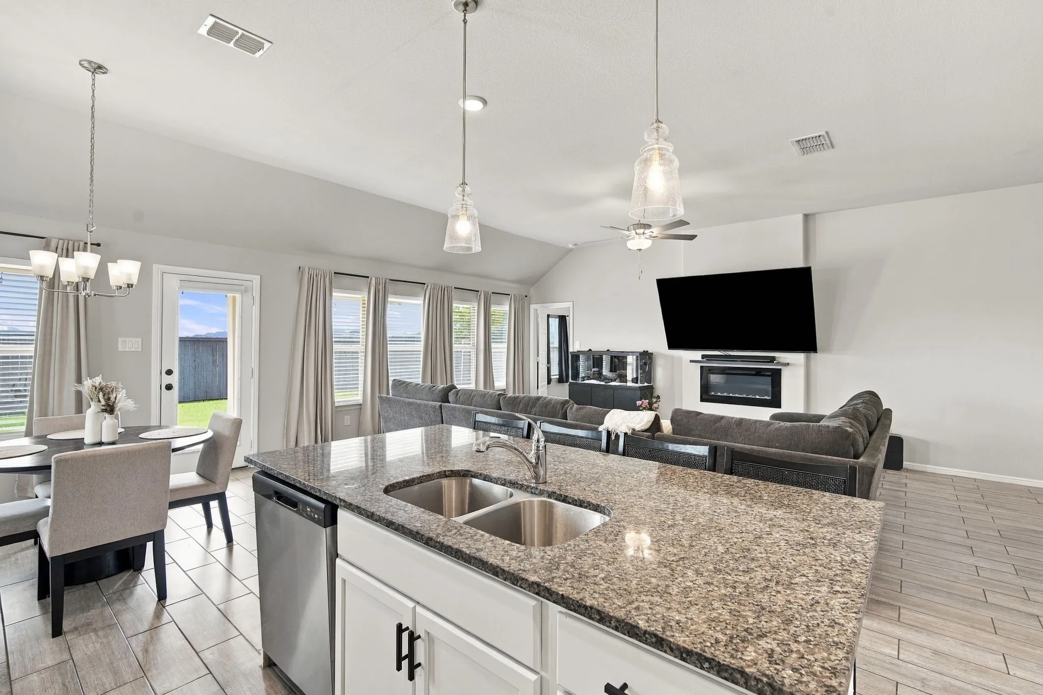 Kitchen island with stone-finish countertop and undermount double sink