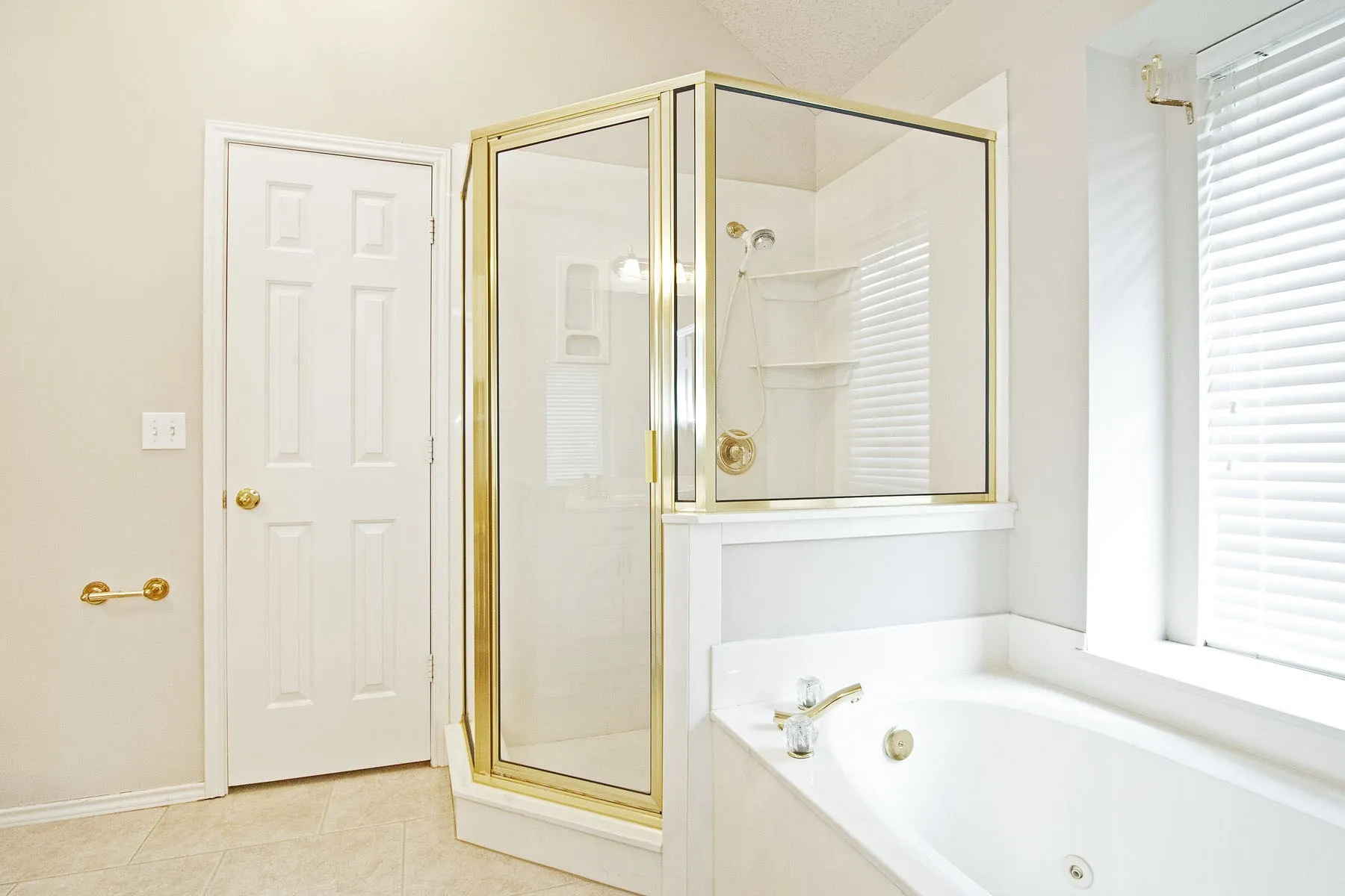 Bathroom with tile patterned floors, a bath, and a shower stall