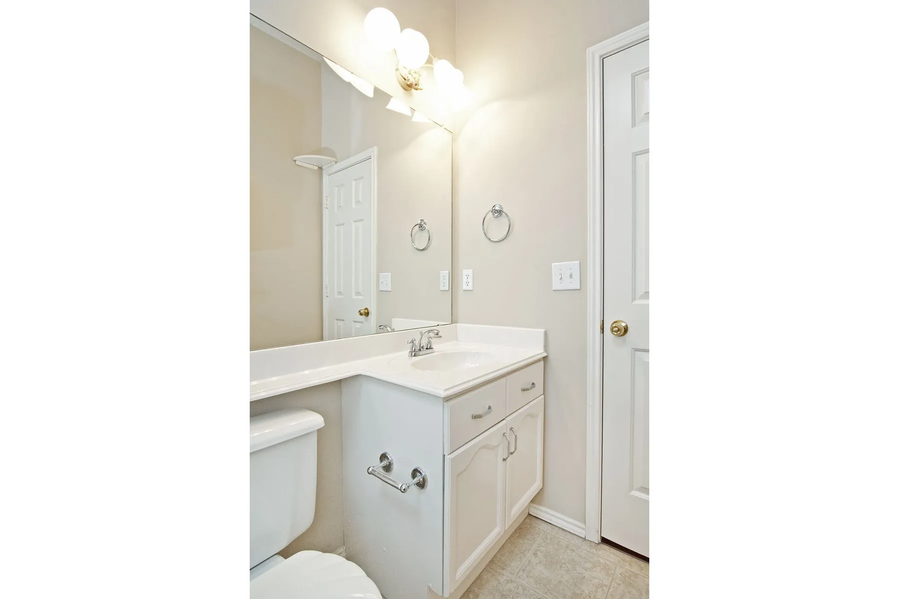 Bathroom featuring toilet, tile patterned floors, and vanity