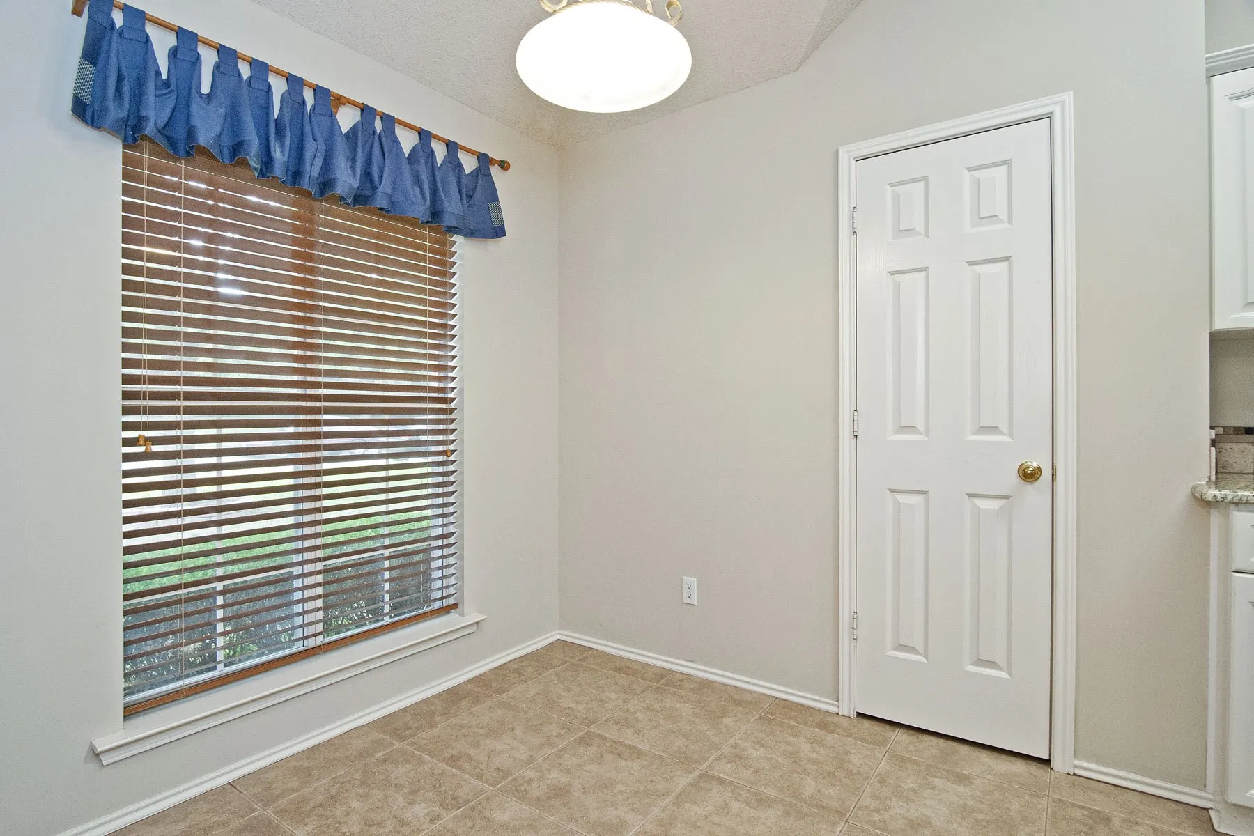 Empty room with baseboards and light tile patterned floors