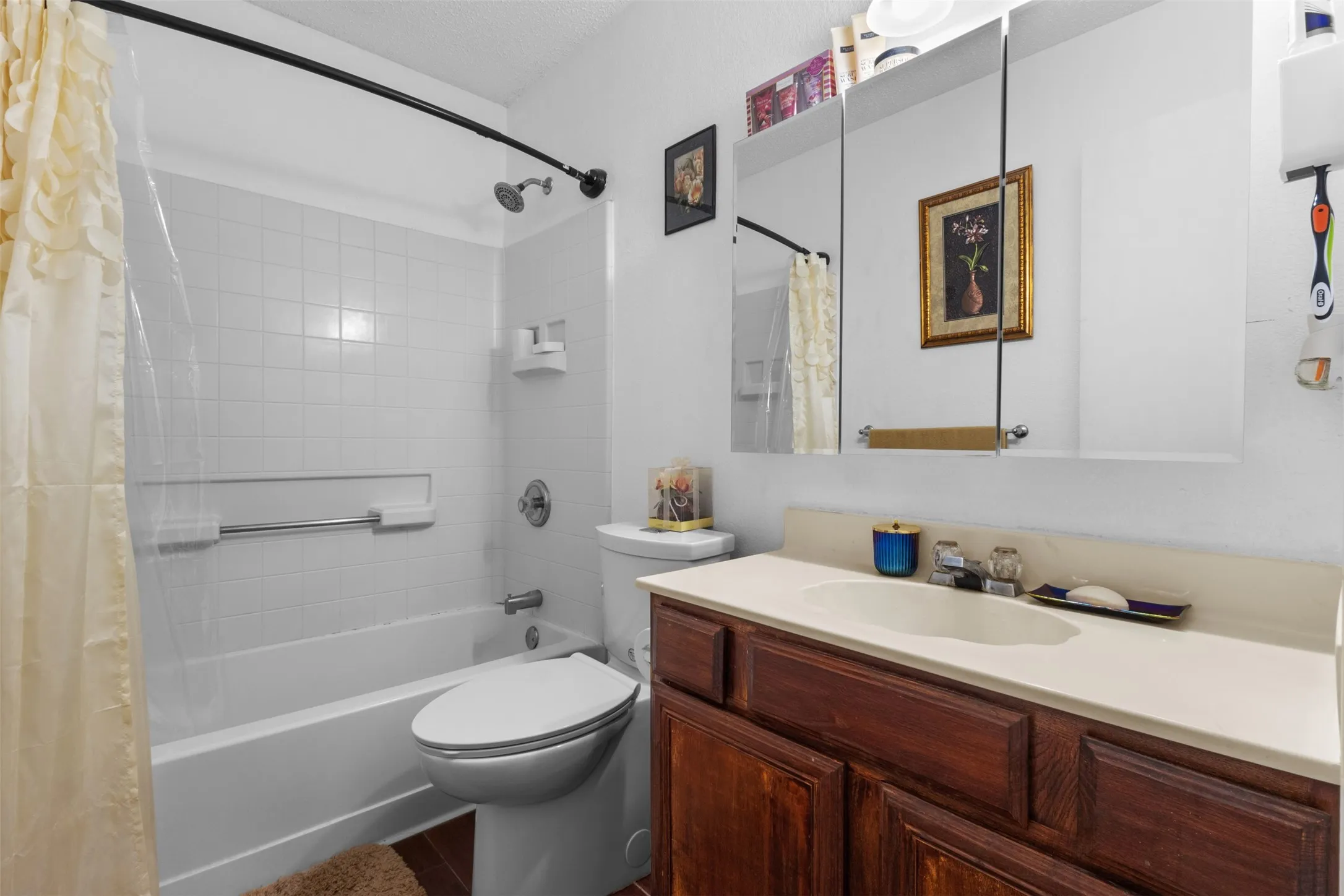 White tiled shower-tub combination with a built-in soap dish