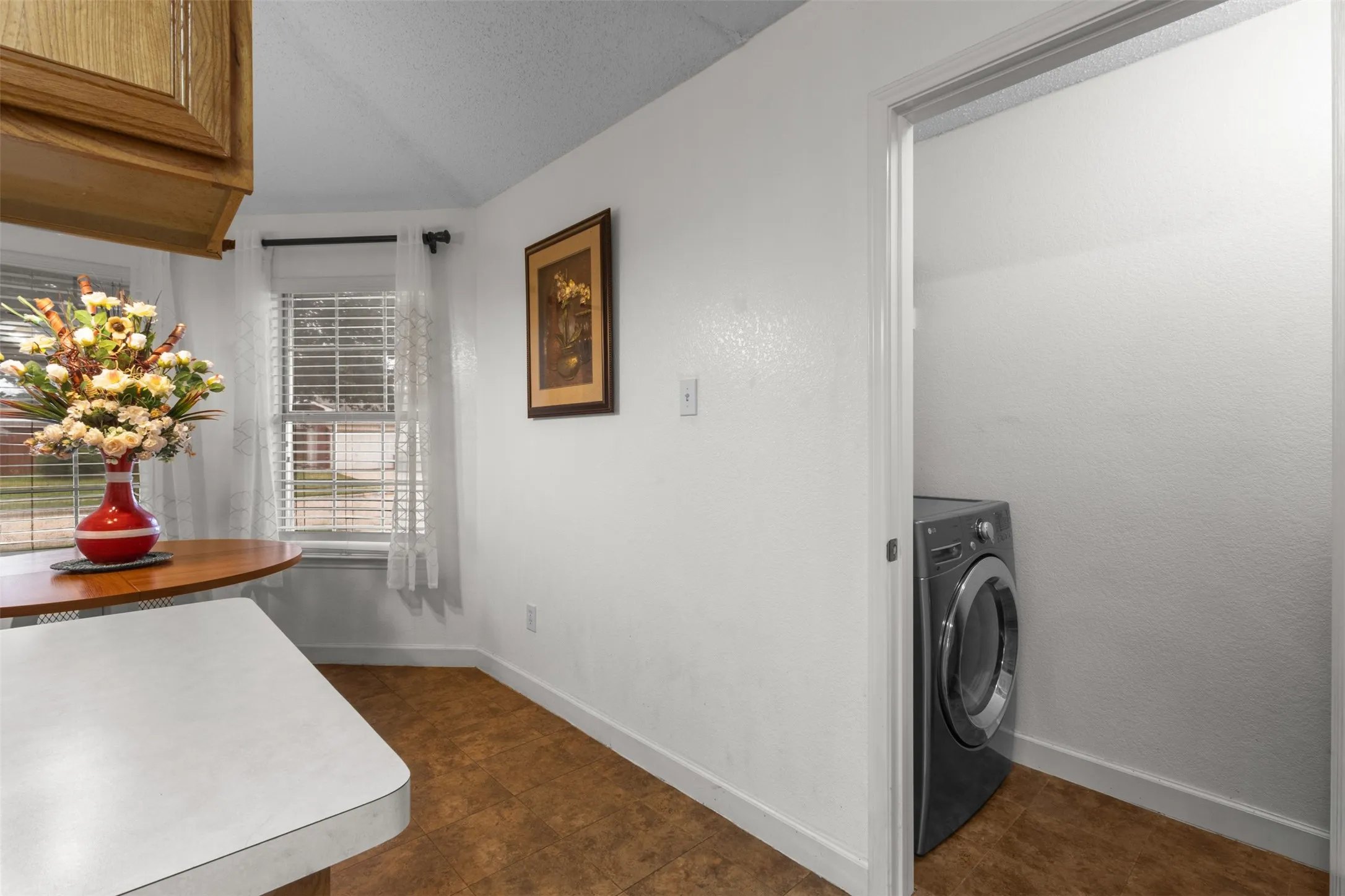 Built-in cabinetry, vinyl flooring, and a dedicated laundry alcove