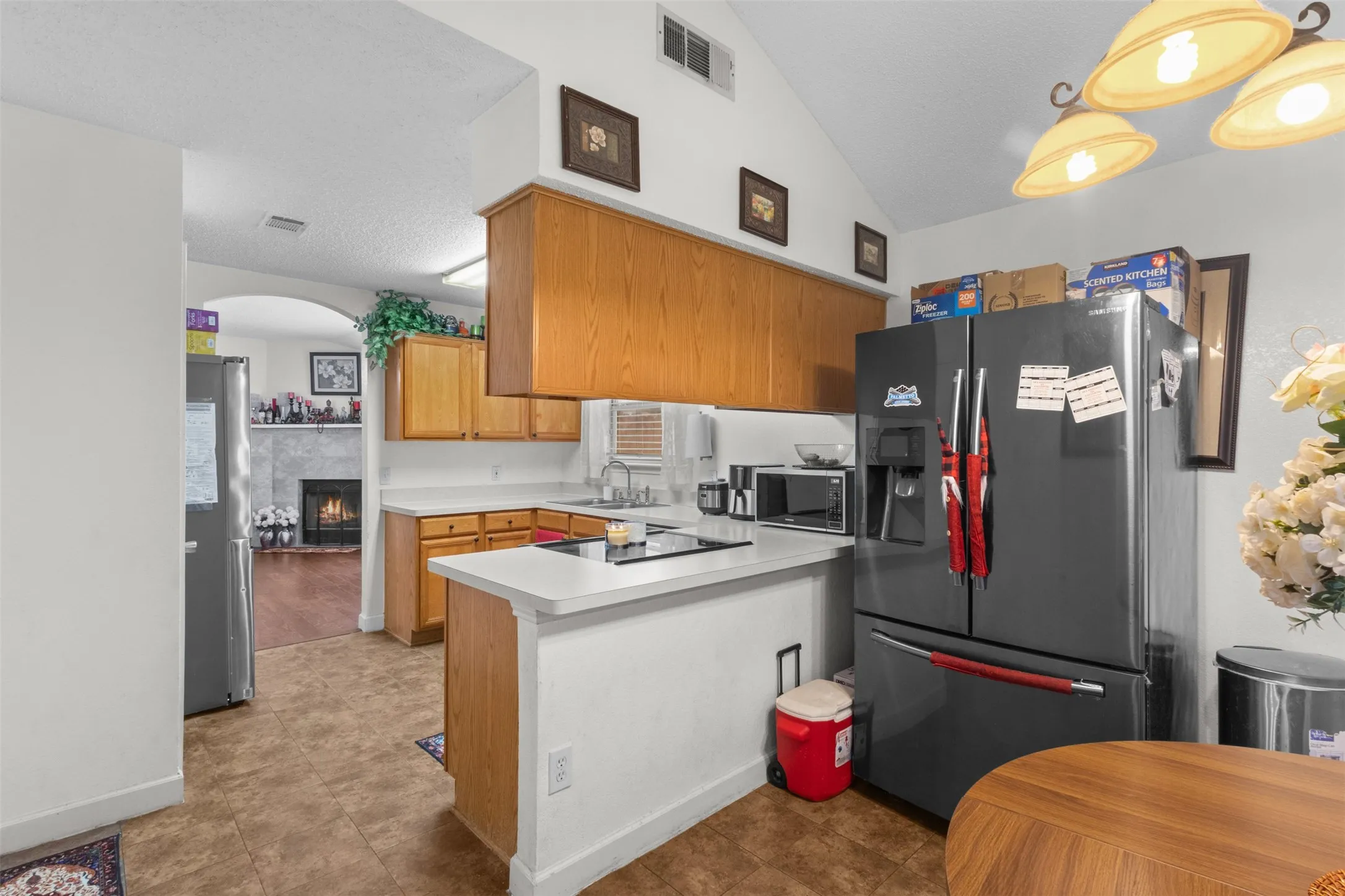 Kitchen featuring wood cabinetry, white countertops, and a built-in cooktop