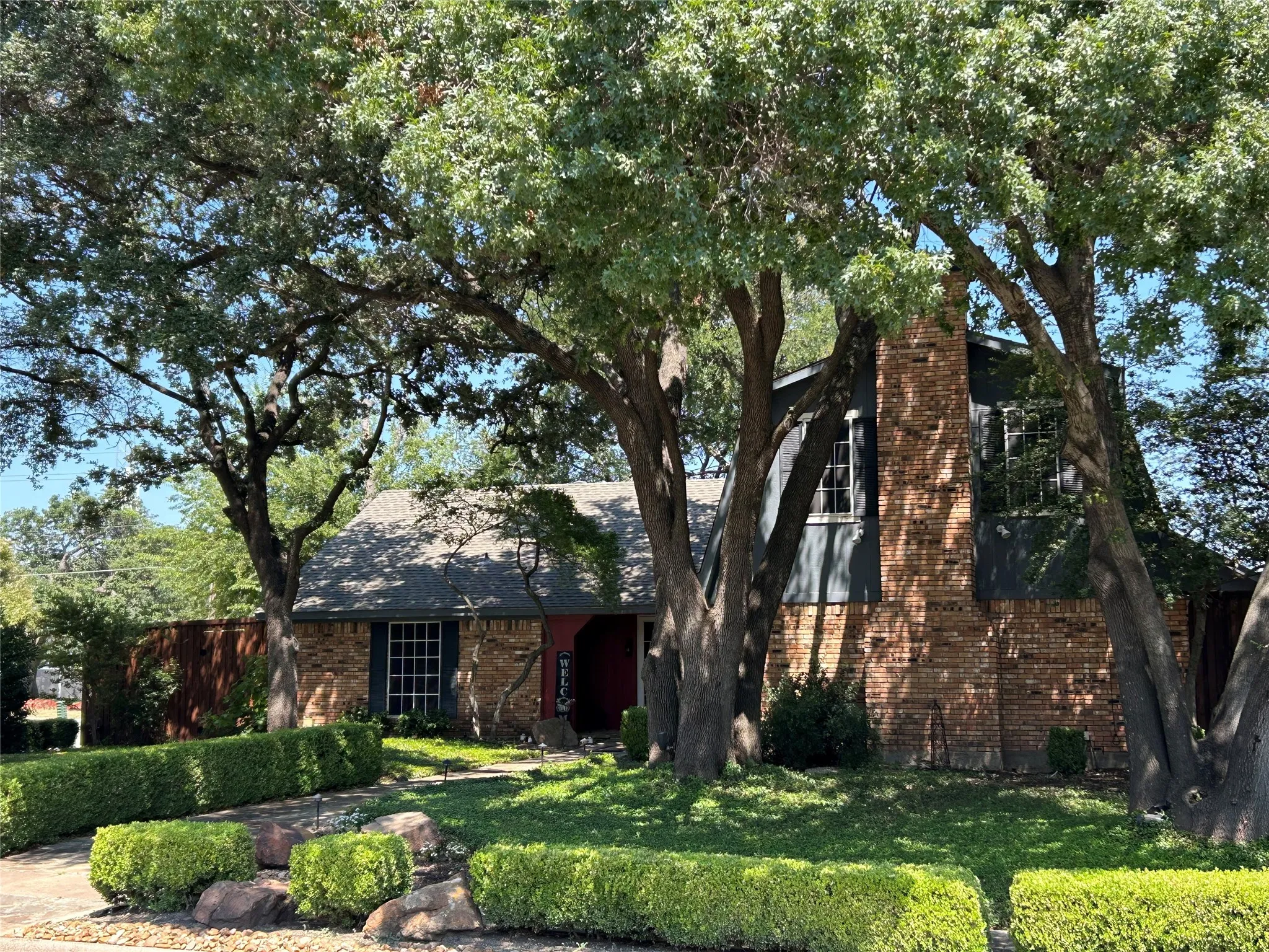 The brick home features shudders, updated windows, and solar window screens.