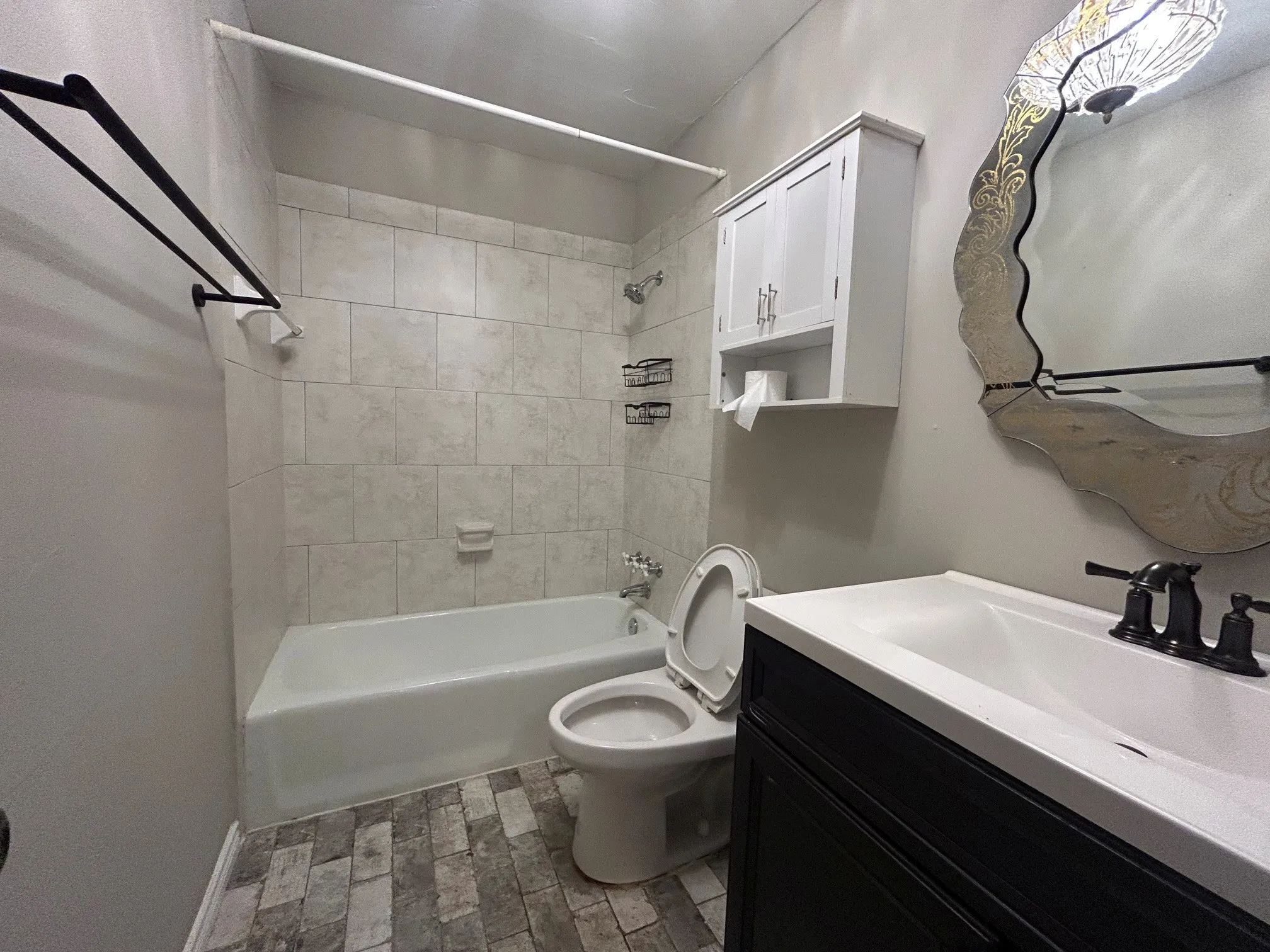 The first-floor bathroom features a vanity with a full bathtub and shower.