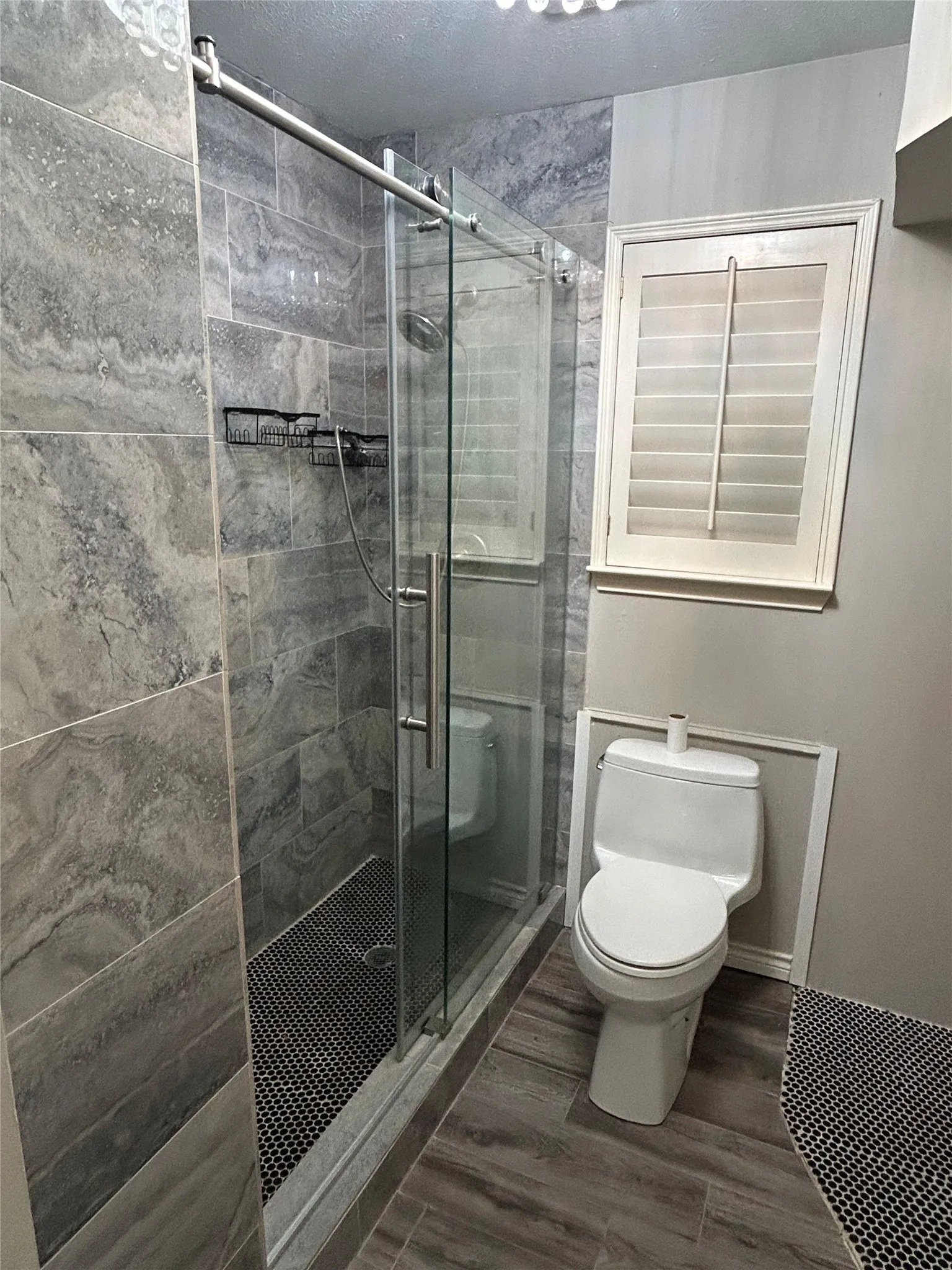 The primary bathroom has a new glass-enclosed shower.
