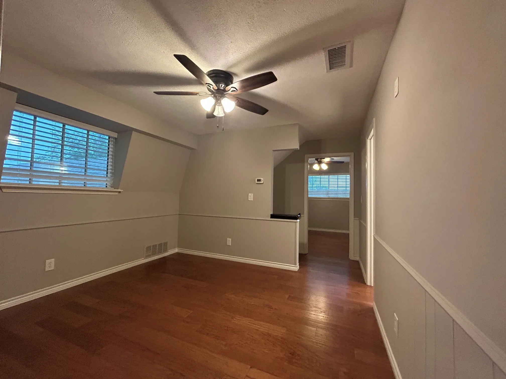 The second-floor game room is adjacent to the two upper floor bedrooms and bathroom.