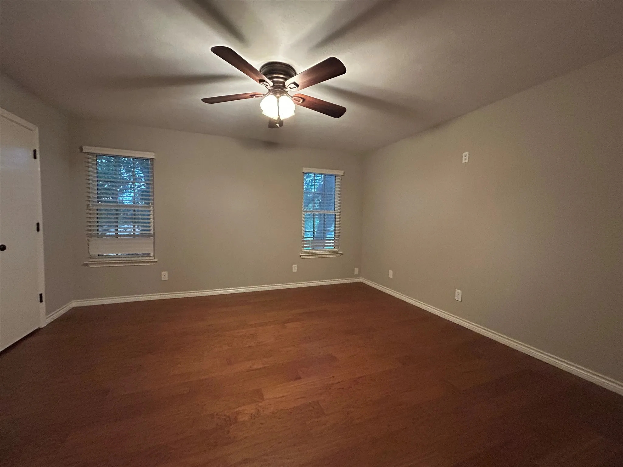 There are two large bedrooms on the second floor with ceiling fans, hardwood floors, and walk-in closets.