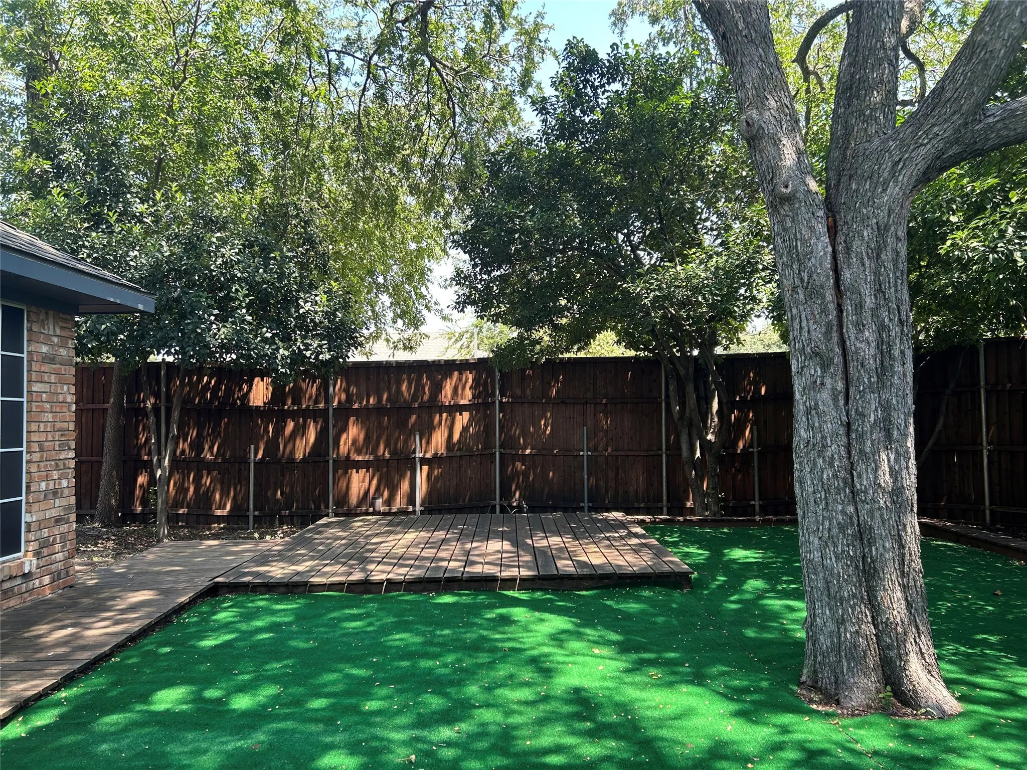 The yard is fully fenced and has an additional deck for outdoor furniture and grilling.