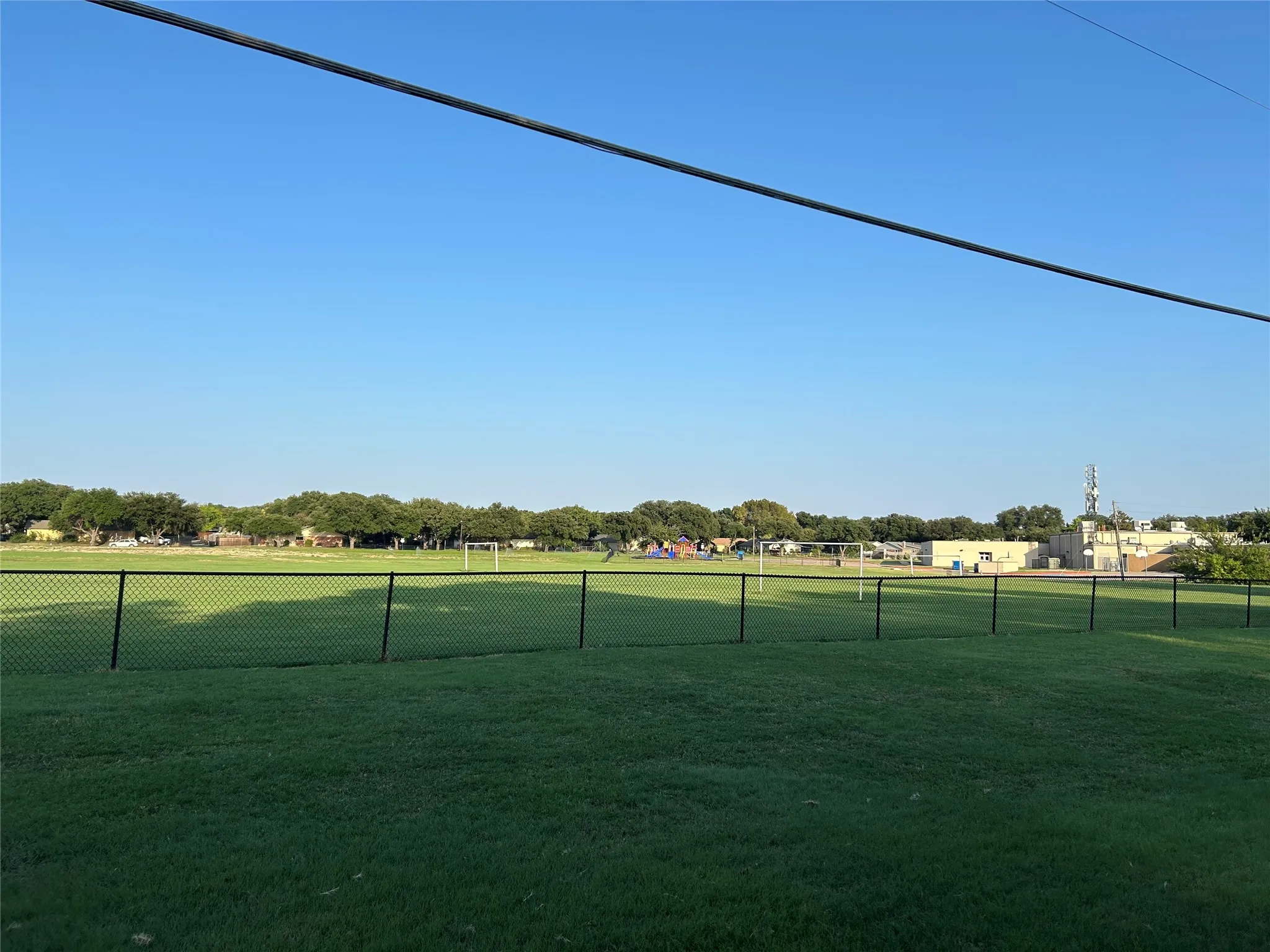 This is a view from behind the house.  There are no neighbors and the property is part of Christie Elementary school.