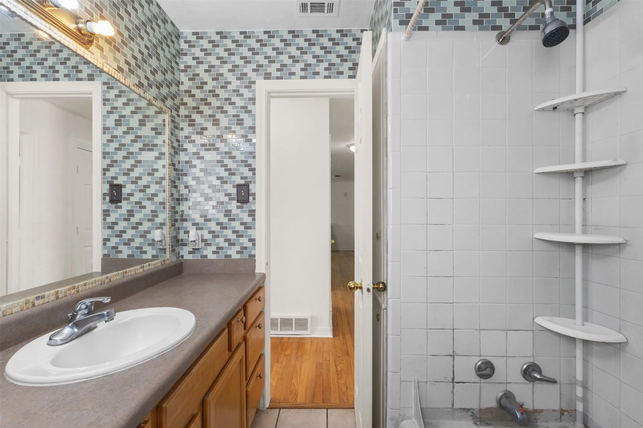 Vanity with an integrated sink, chrome faucet, and wood-finish cabinetry