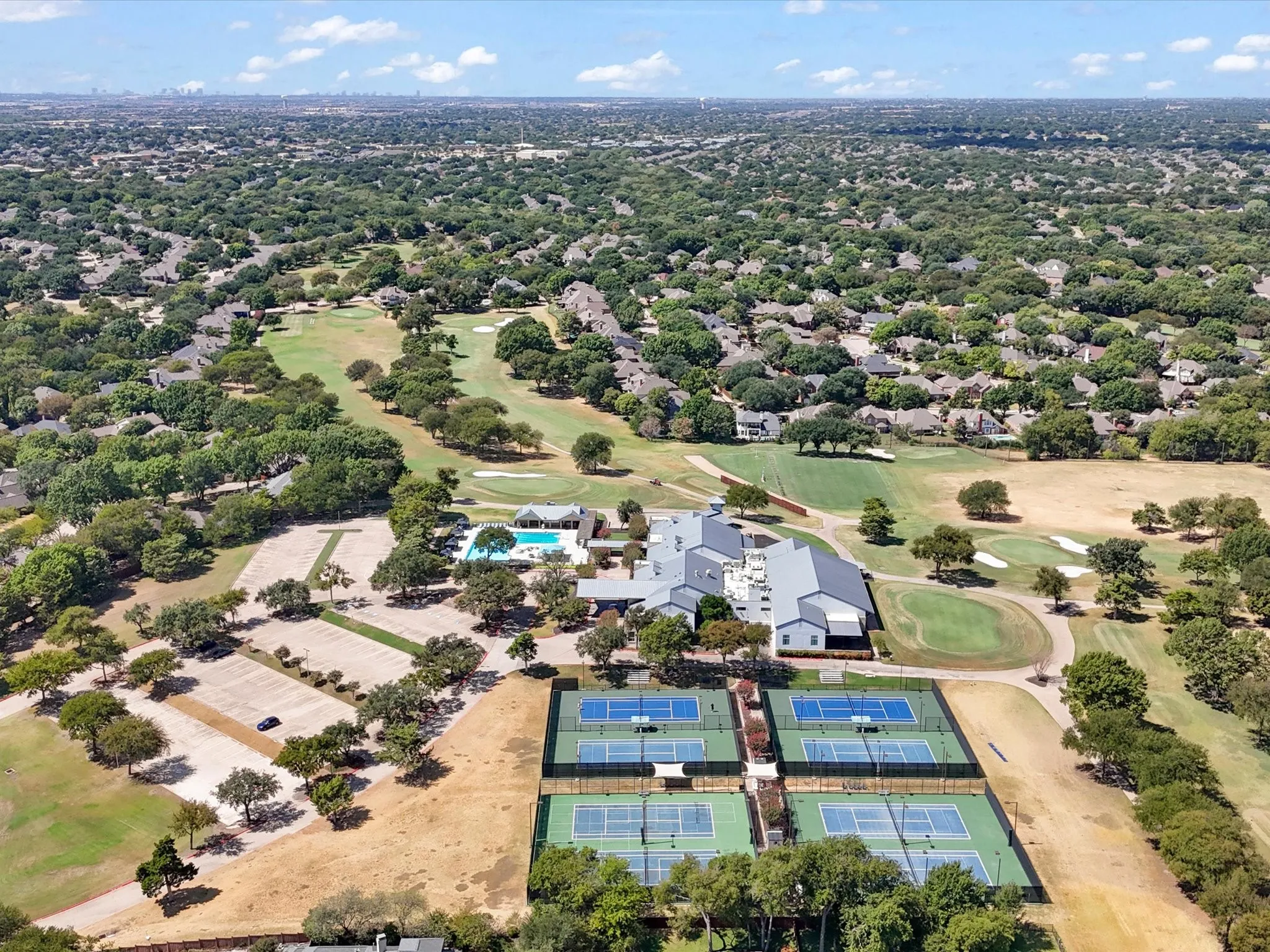 Expansive golf course setting featuring multiple greens and fairways