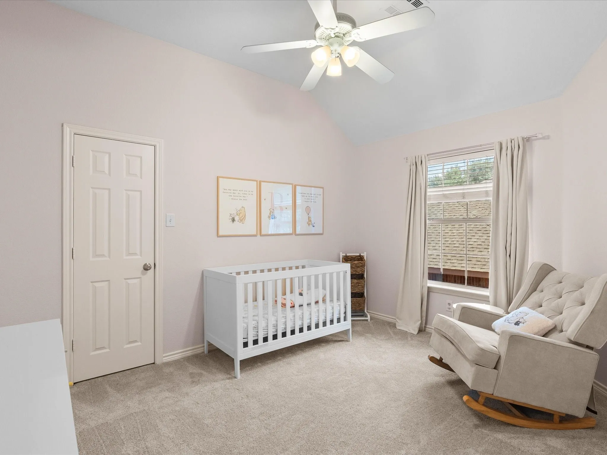 Vaulted ceiling with a ceiling fan, light gray carpeting, and a window with blinds