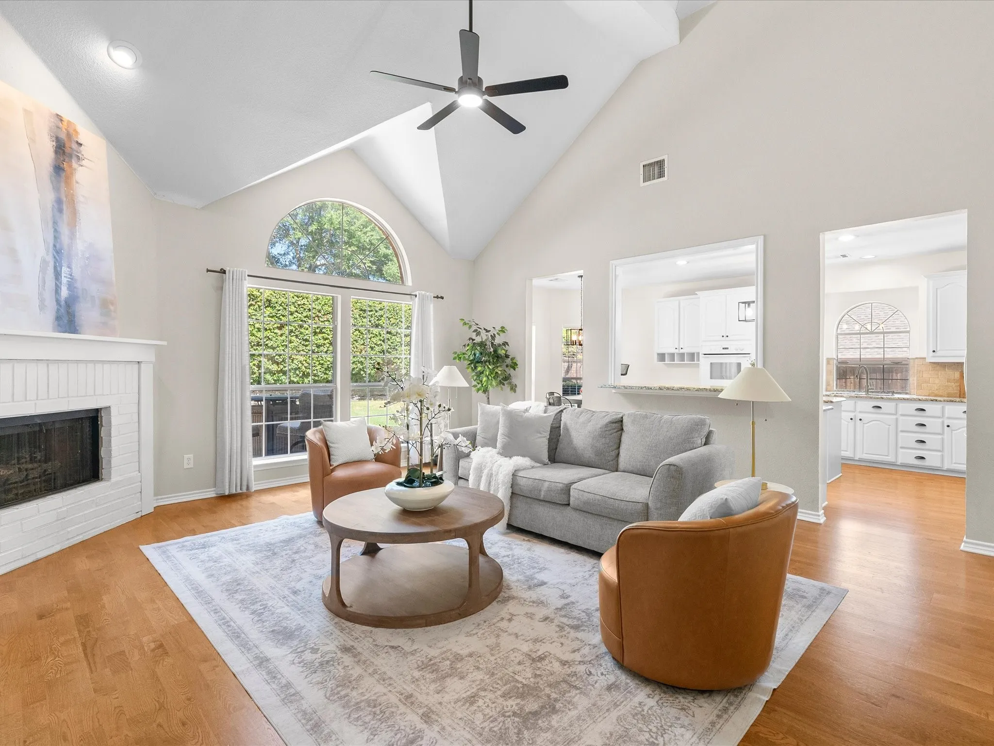 Vaulted ceiling with recessed lighting and a ceiling fan