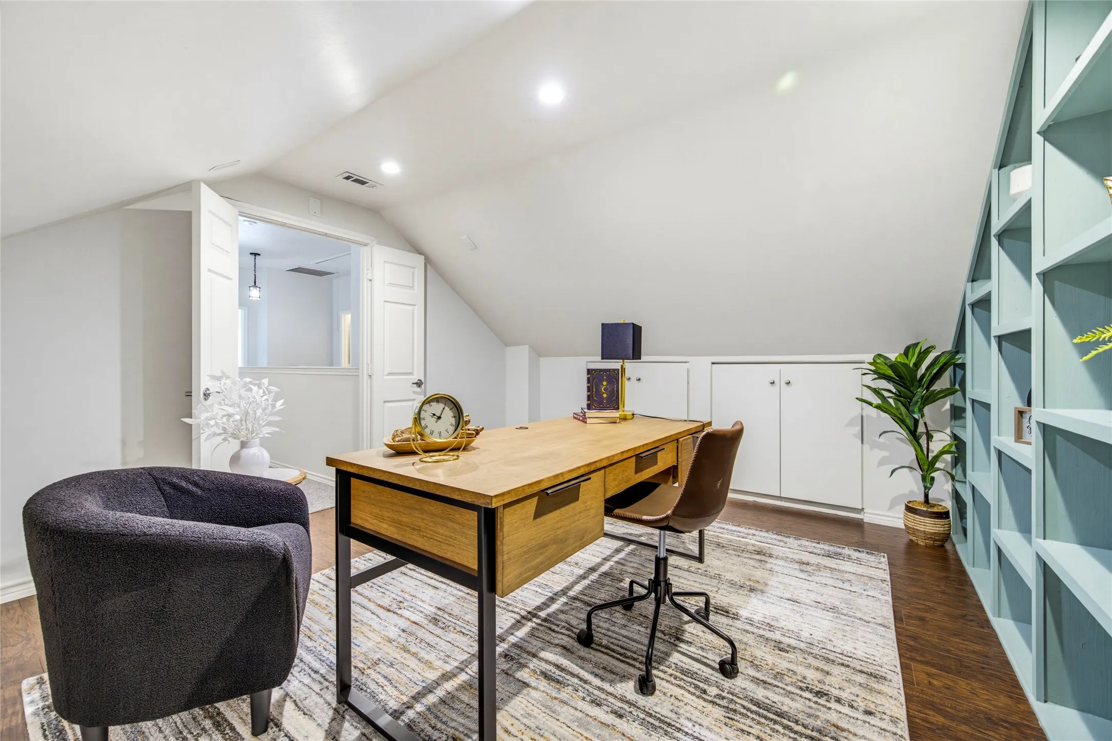 Space for a full desk setup plus a reading chair, with built-ins that keep books, files, and décor organized.
