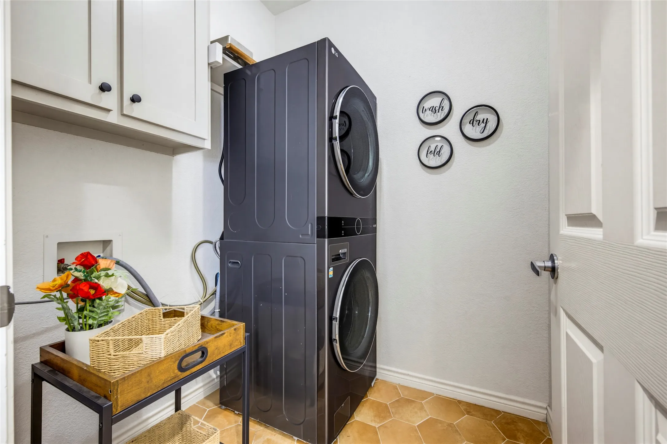 A functional utility room with shelving and storage, and the versatile stackable or side by side washer and dryer convey.
