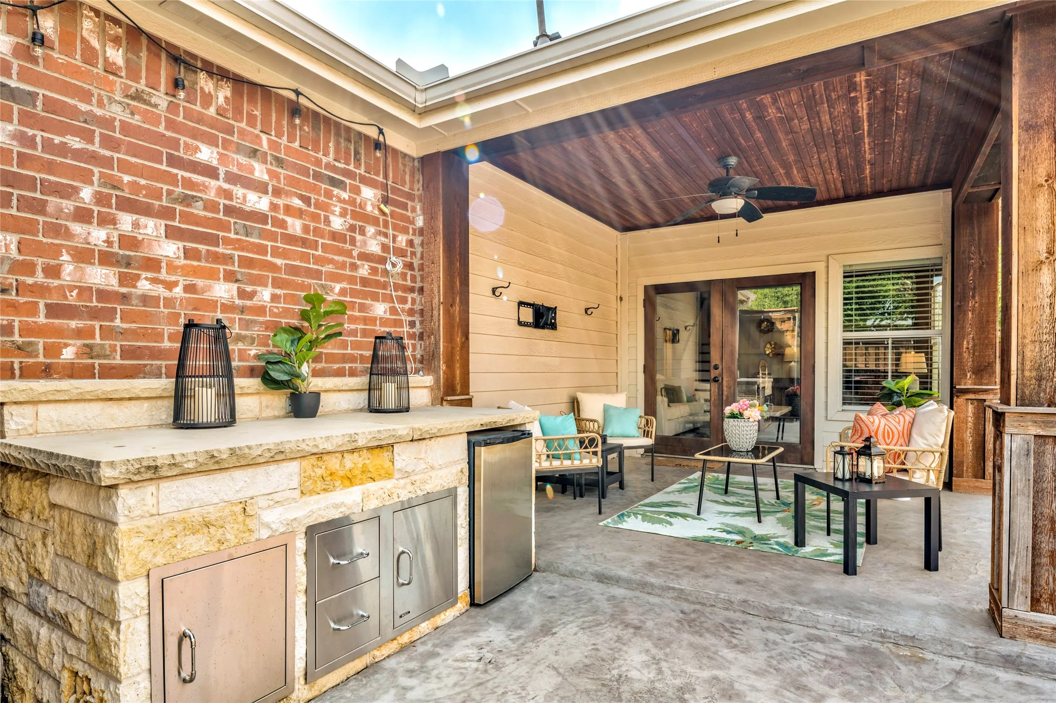 The covered patio features an outdoor counter with a gas line already in place, ready for your grill setup and game-day menu.