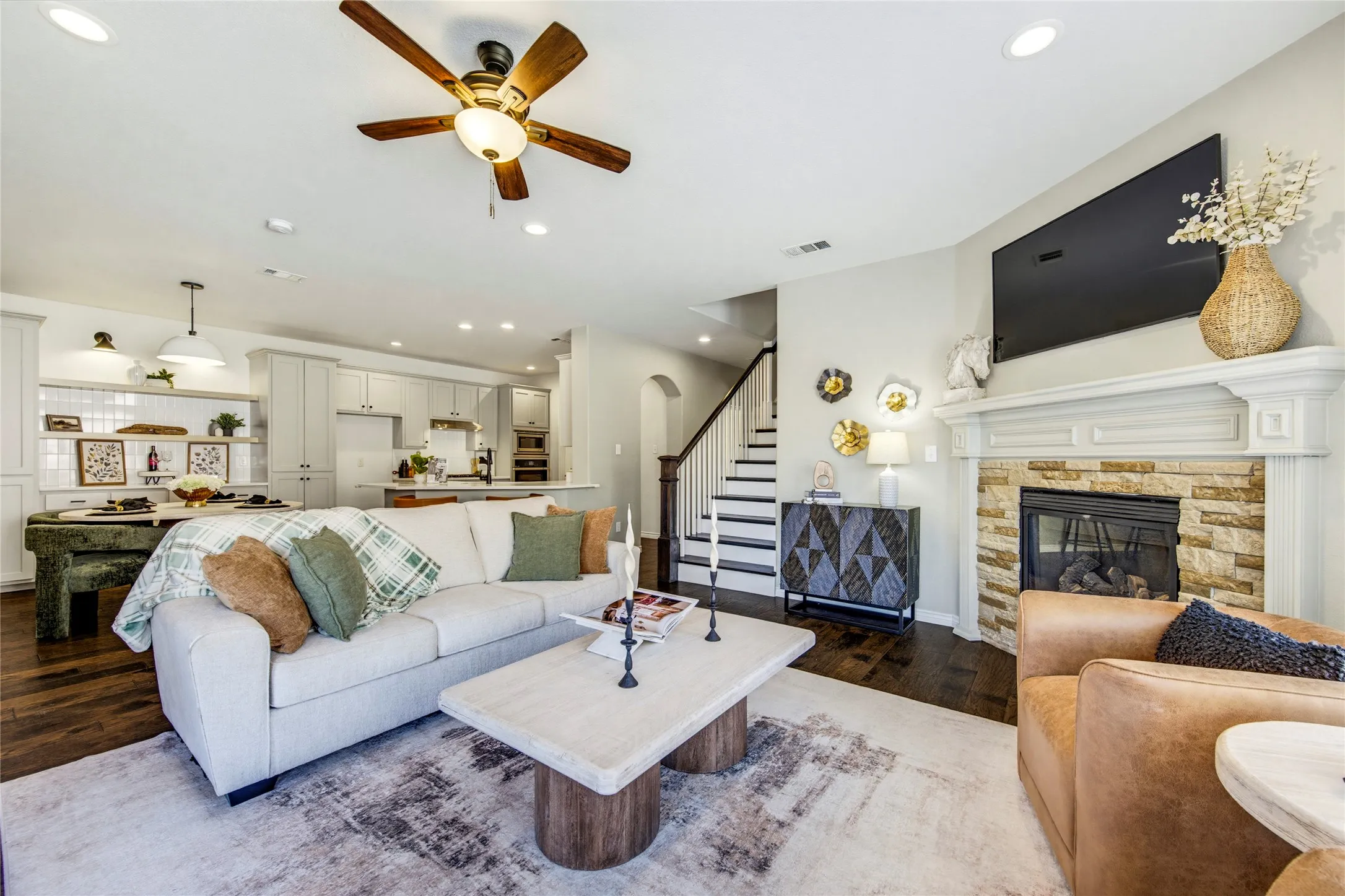 Open to the kitchen and breakfast area, this bright living space keeps the cook in the conversation and the game in view.
