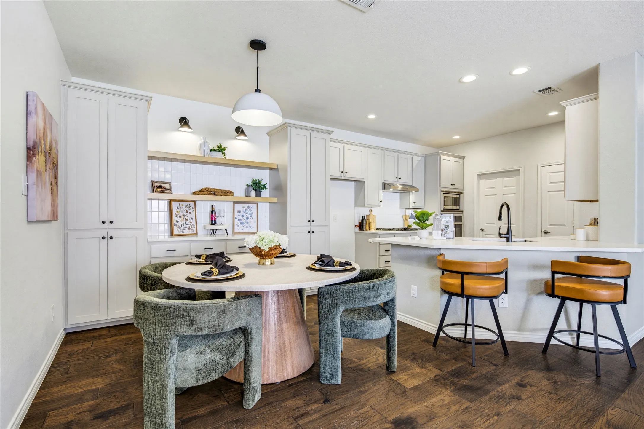 The renovated kitchen's breakfast bar pulls up stools for morning coffee, casual meals, or appetizers while dinner comes together.
