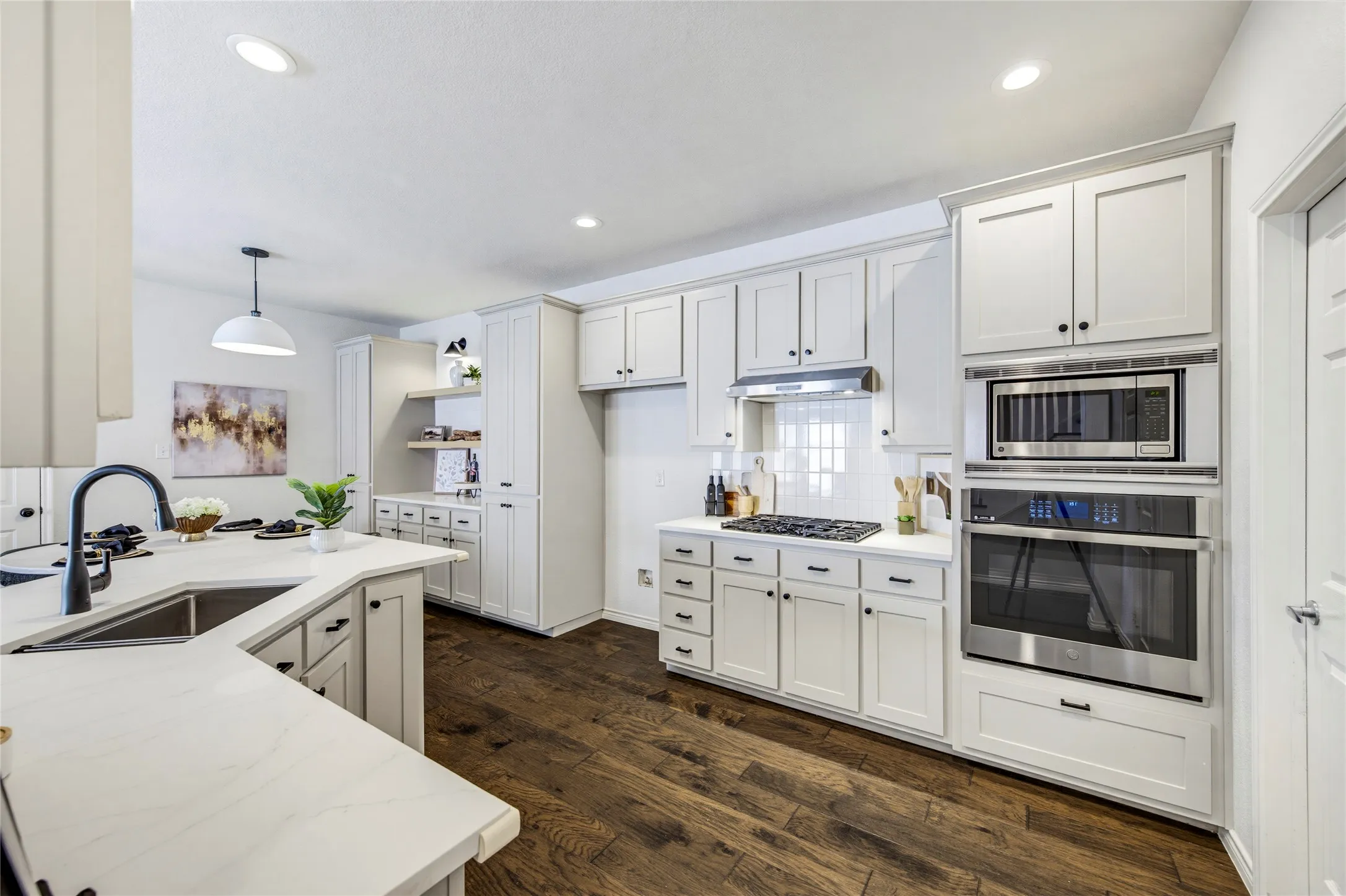 Stainless appliances, a 4-burner gas cooktop, and generous counter and cabinet space make this a kitchen that works as well as it looks.