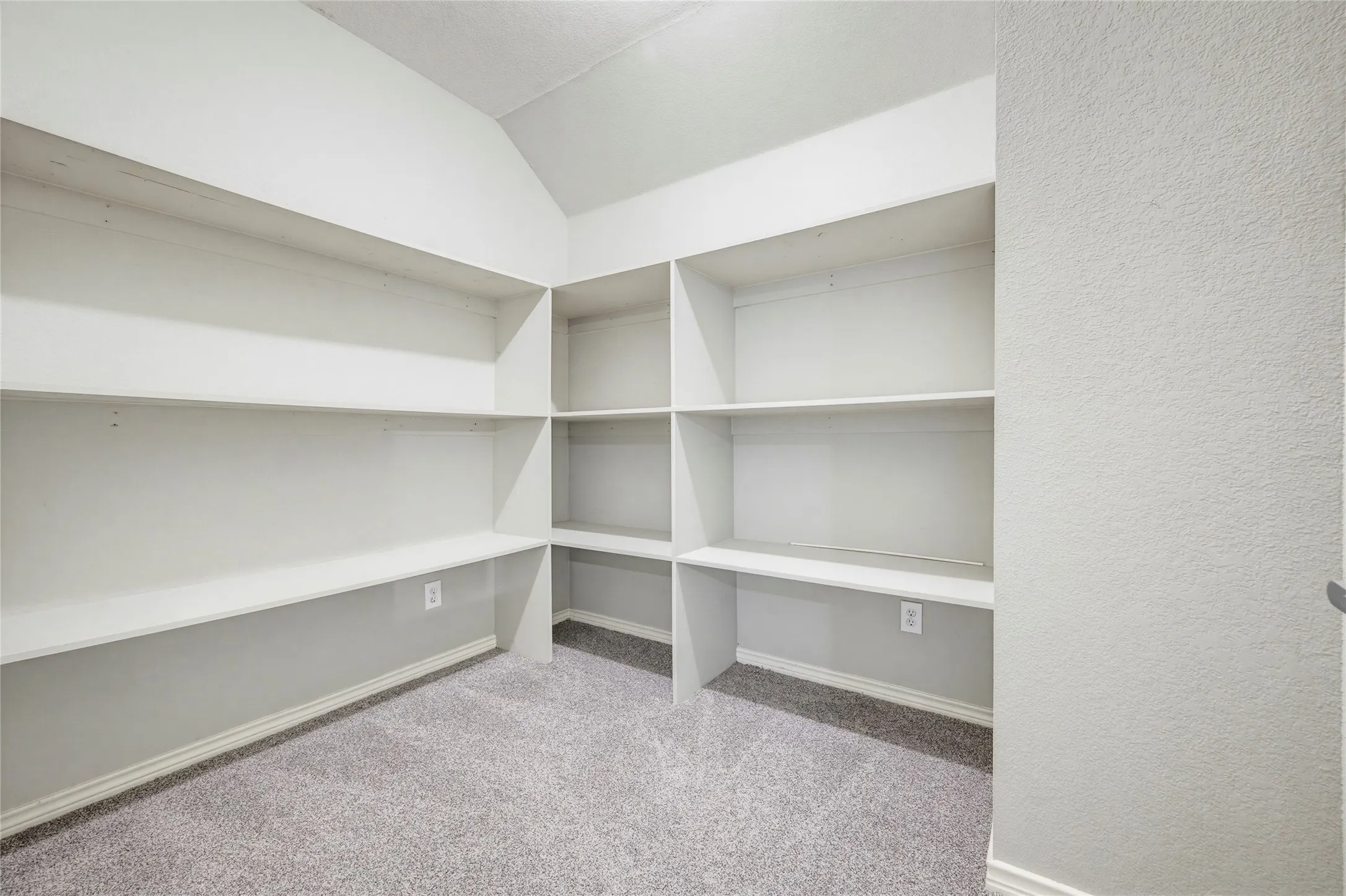 An oversized storage room lined with deep built-in shelving, the unsung hero for seasonal décor, sports gear, and everything in between.
