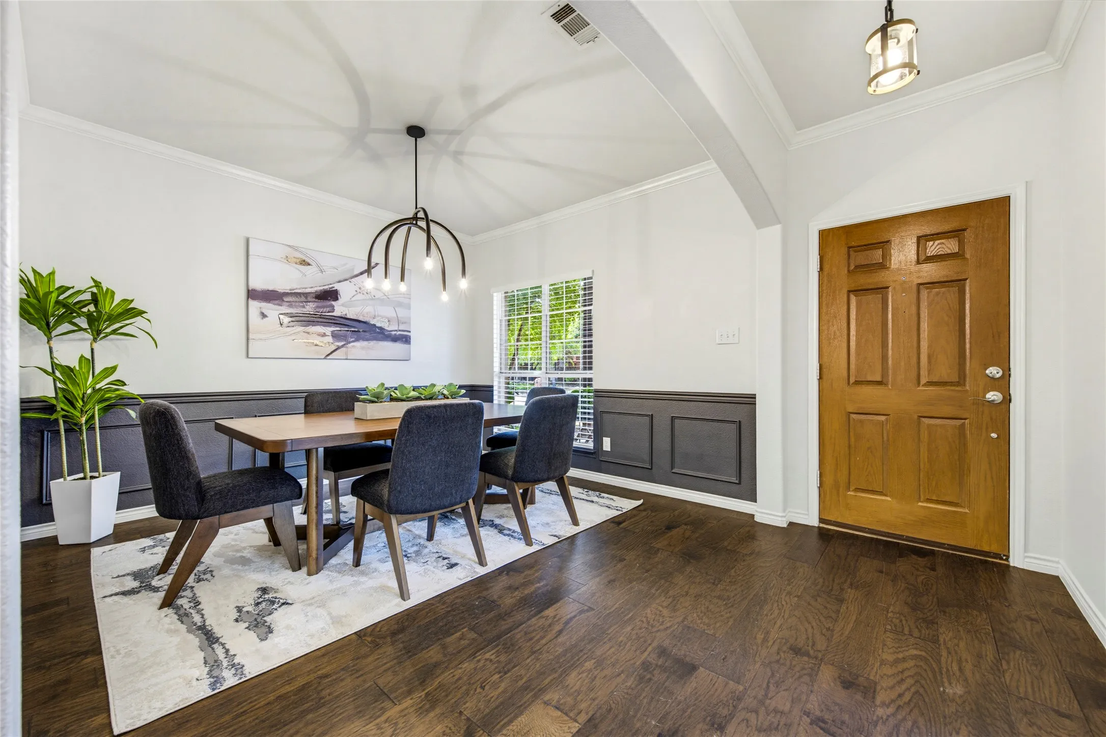 Stylish black wainscoting and rich hardwood floors make a sharp first impression right off the entry, setting the stage for dinners and hosting.