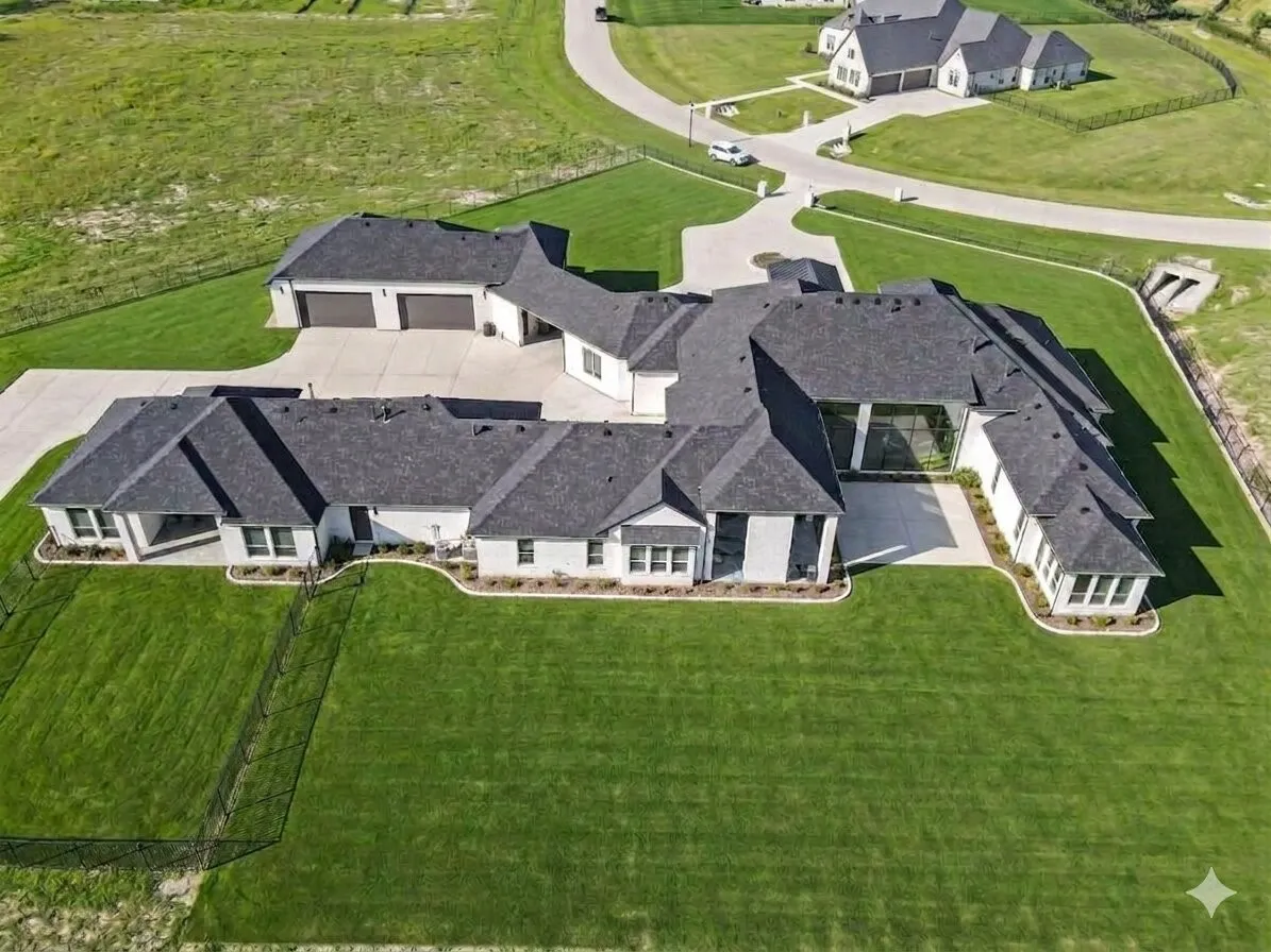 Expansive property featuring a multi-wing design, an attached three-car garage, a detached two-car garage, and a large paved driveway