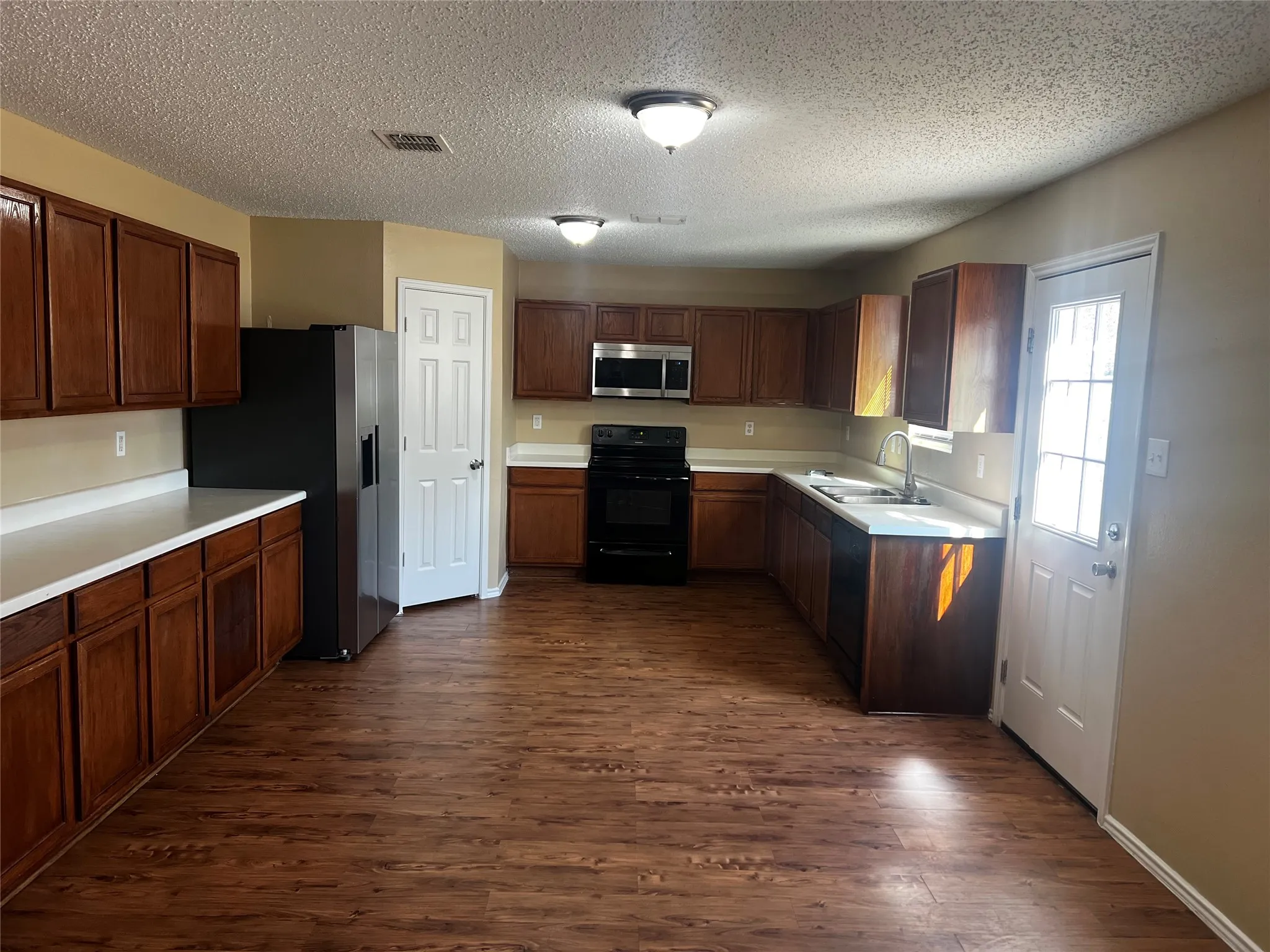 Large Kitchen with refrigerator, stove and microwave